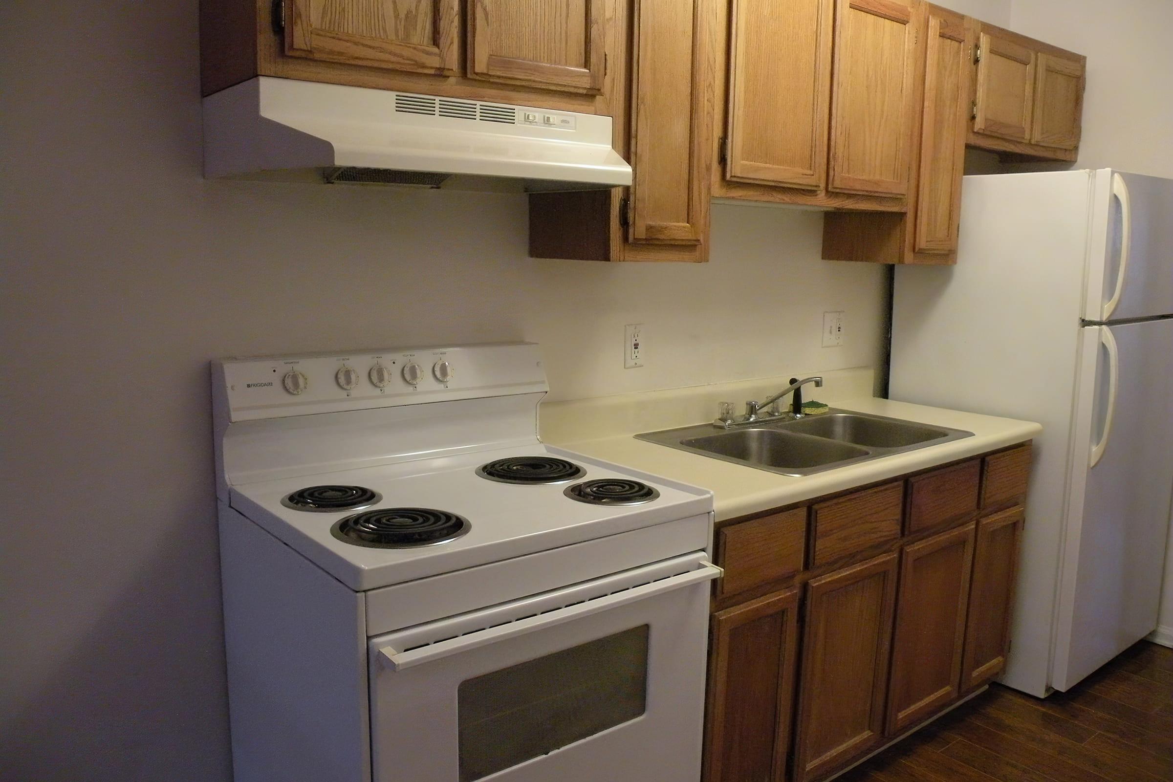 a stove top oven sitting inside of a kitchen