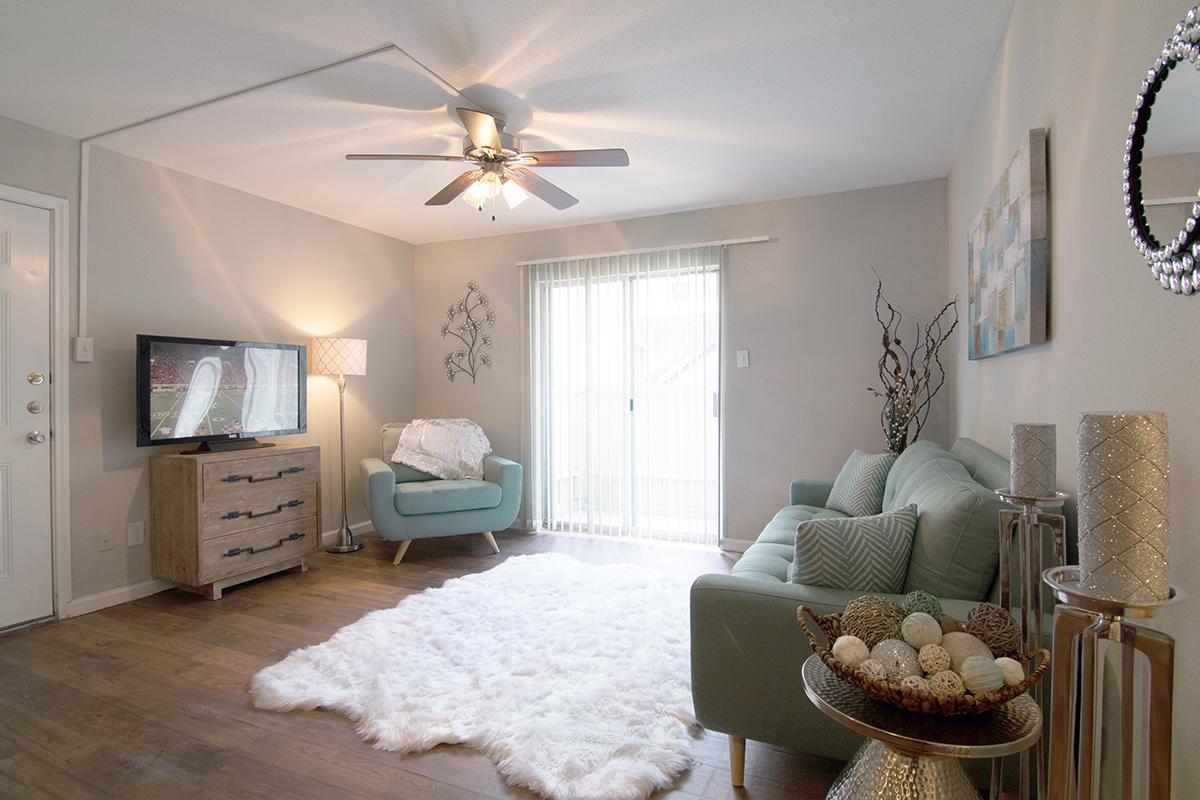 a living room filled with furniture and a bed