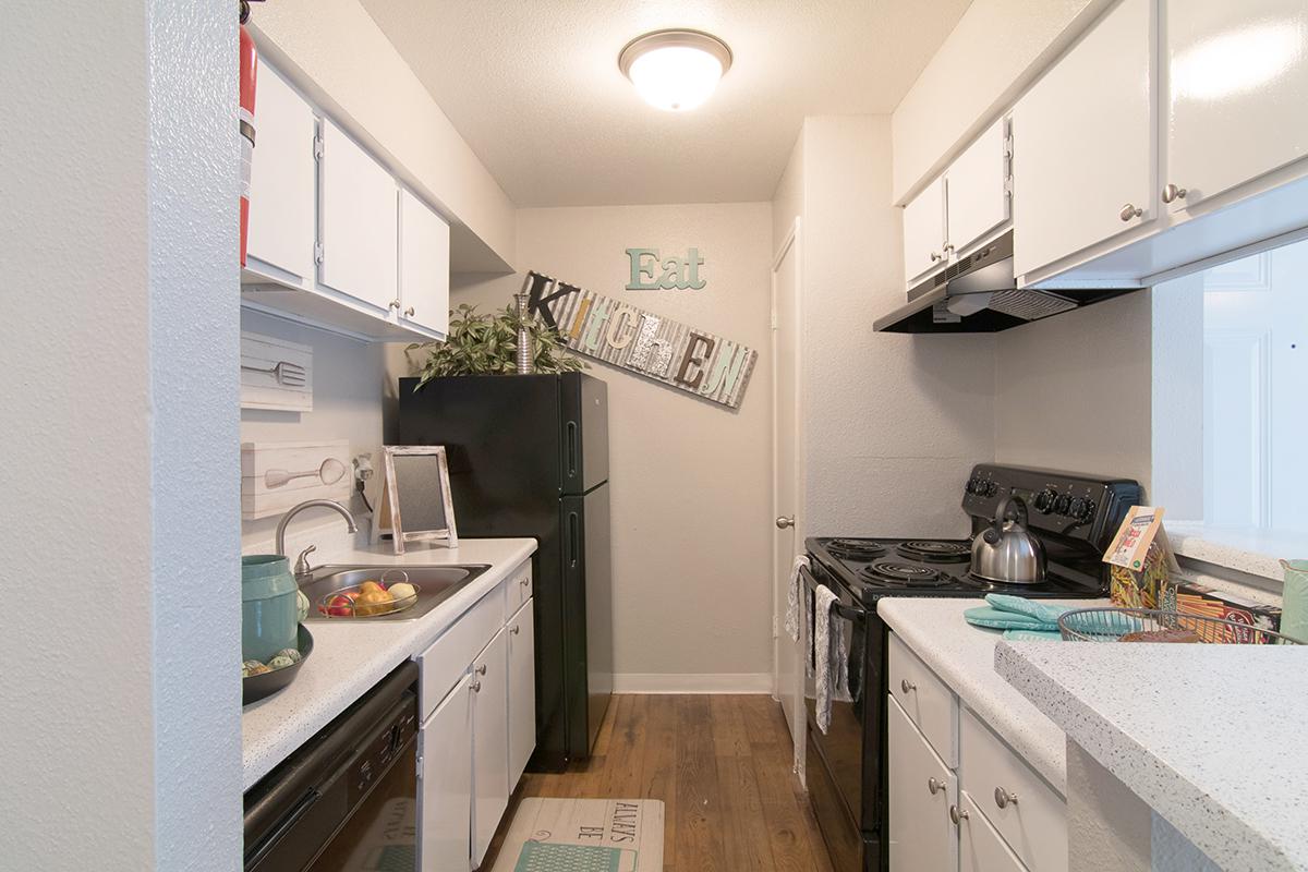 a kitchen with a sink and a refrigerator