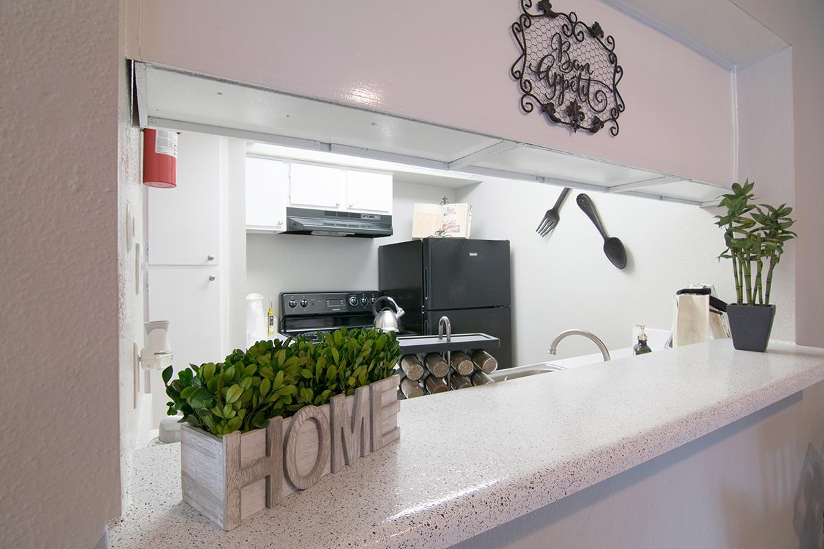 a kitchen with a sink and a mirror