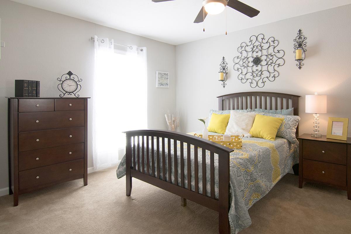 a living room filled with furniture and a bed in a bedroom