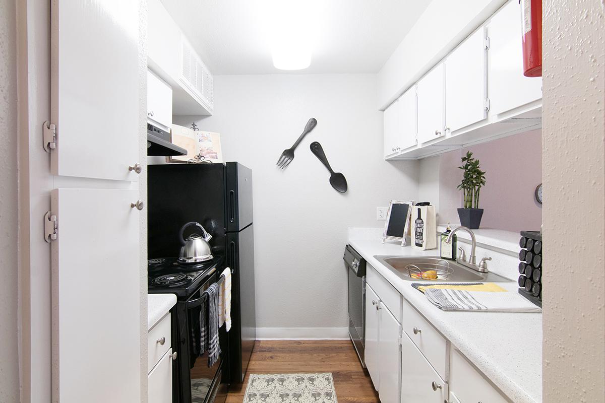 a kitchen with a sink and a refrigerator