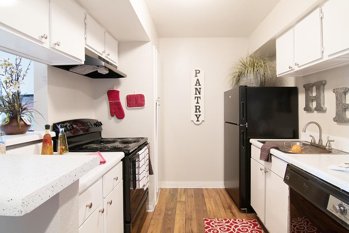 a kitchen with a sink and a mirror