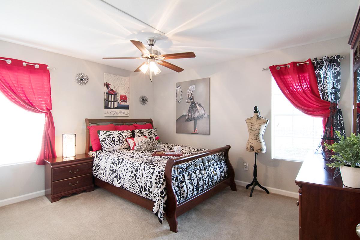 a living room filled with furniture and a bed