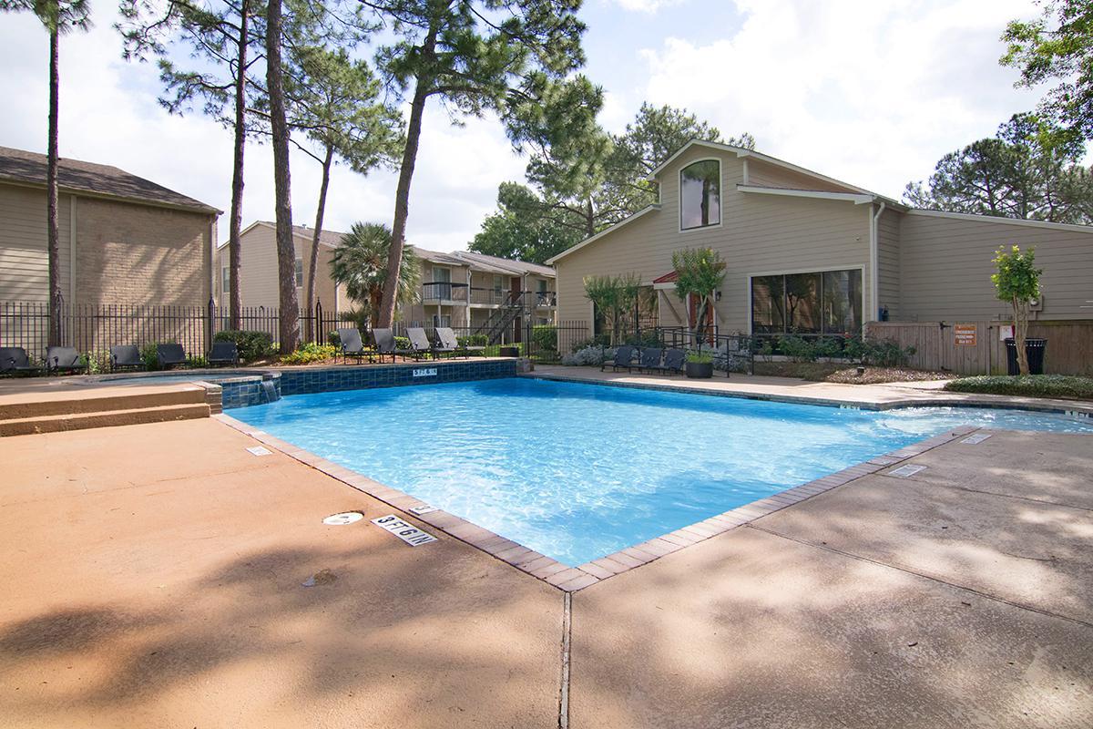 a house with a pool in front of a building