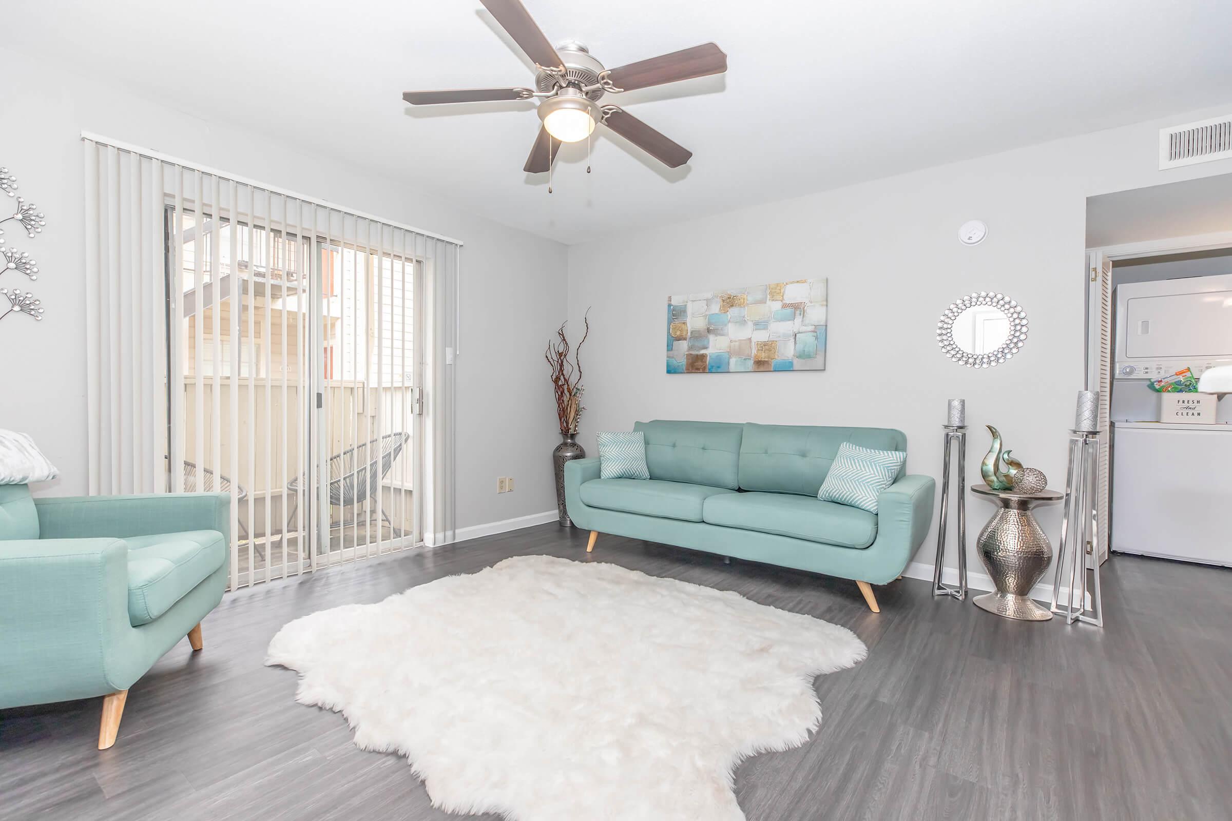 a living room filled with furniture and a flat screen tv