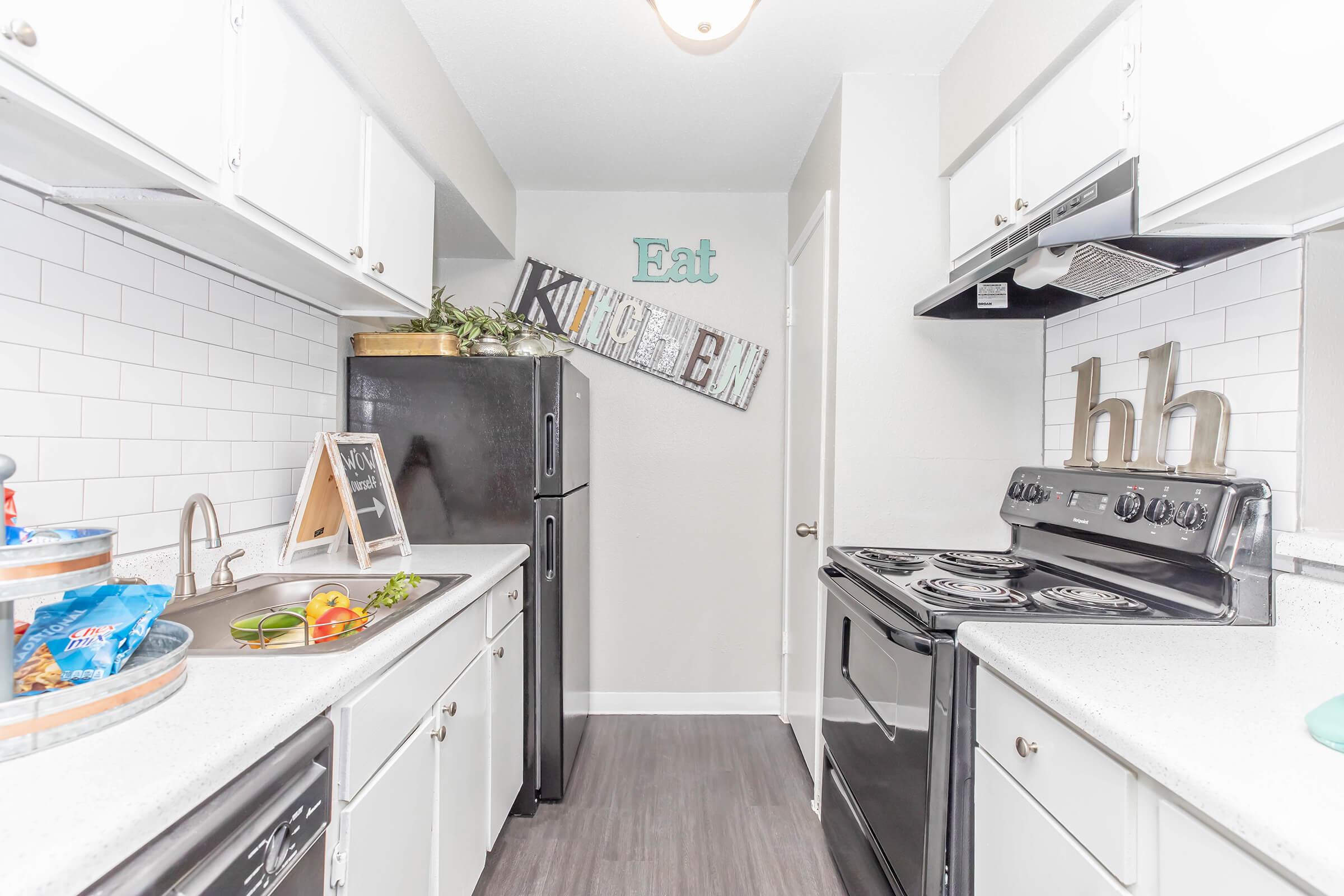 a kitchen with a sink and a refrigerator