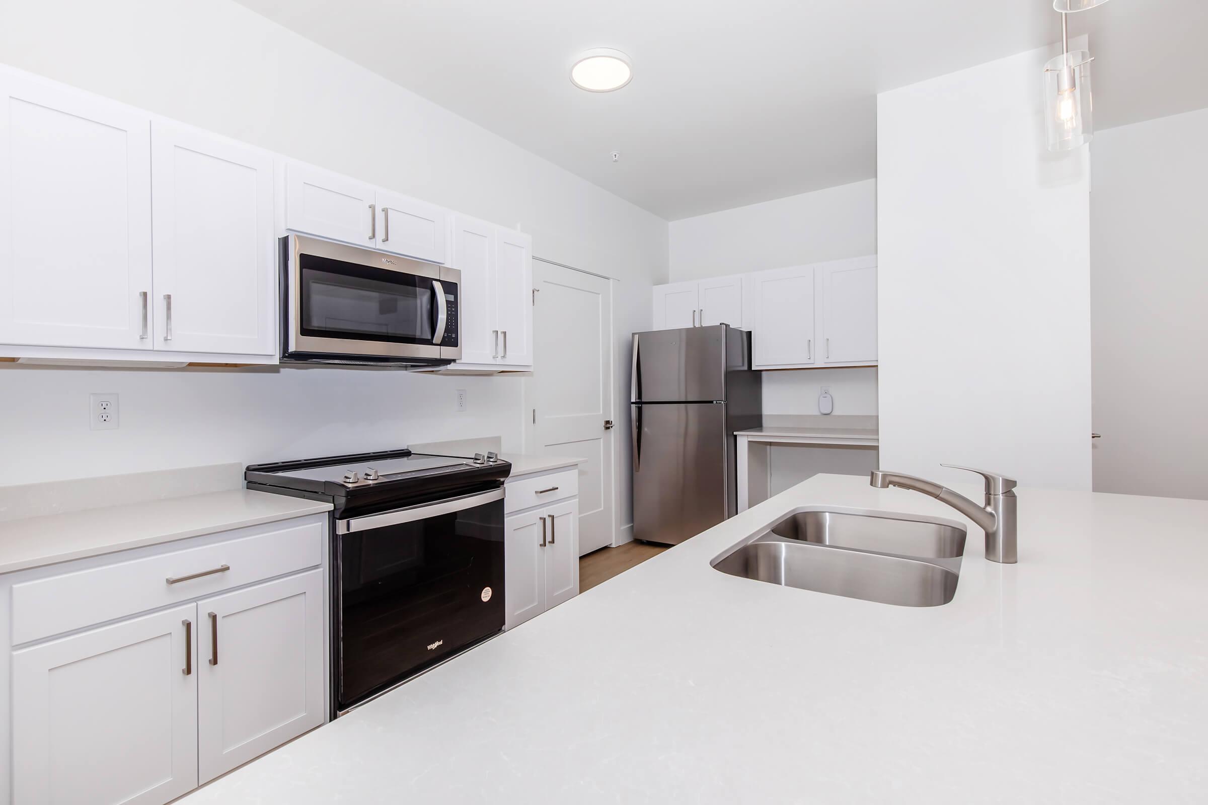 a kitchen with a sink and a refrigerator