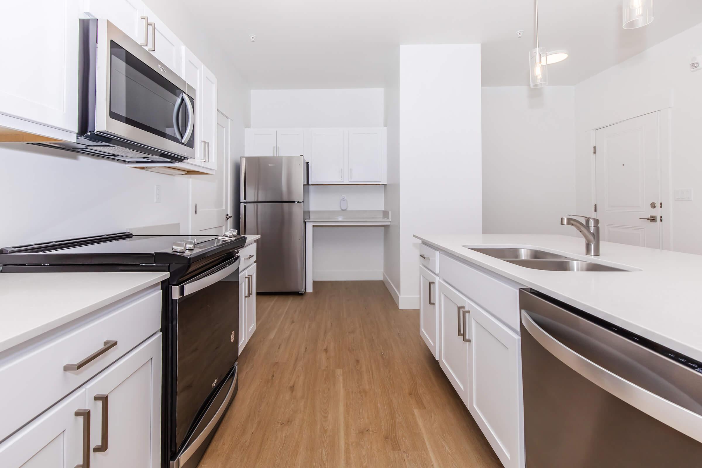 a kitchen with a stove and a refrigerator