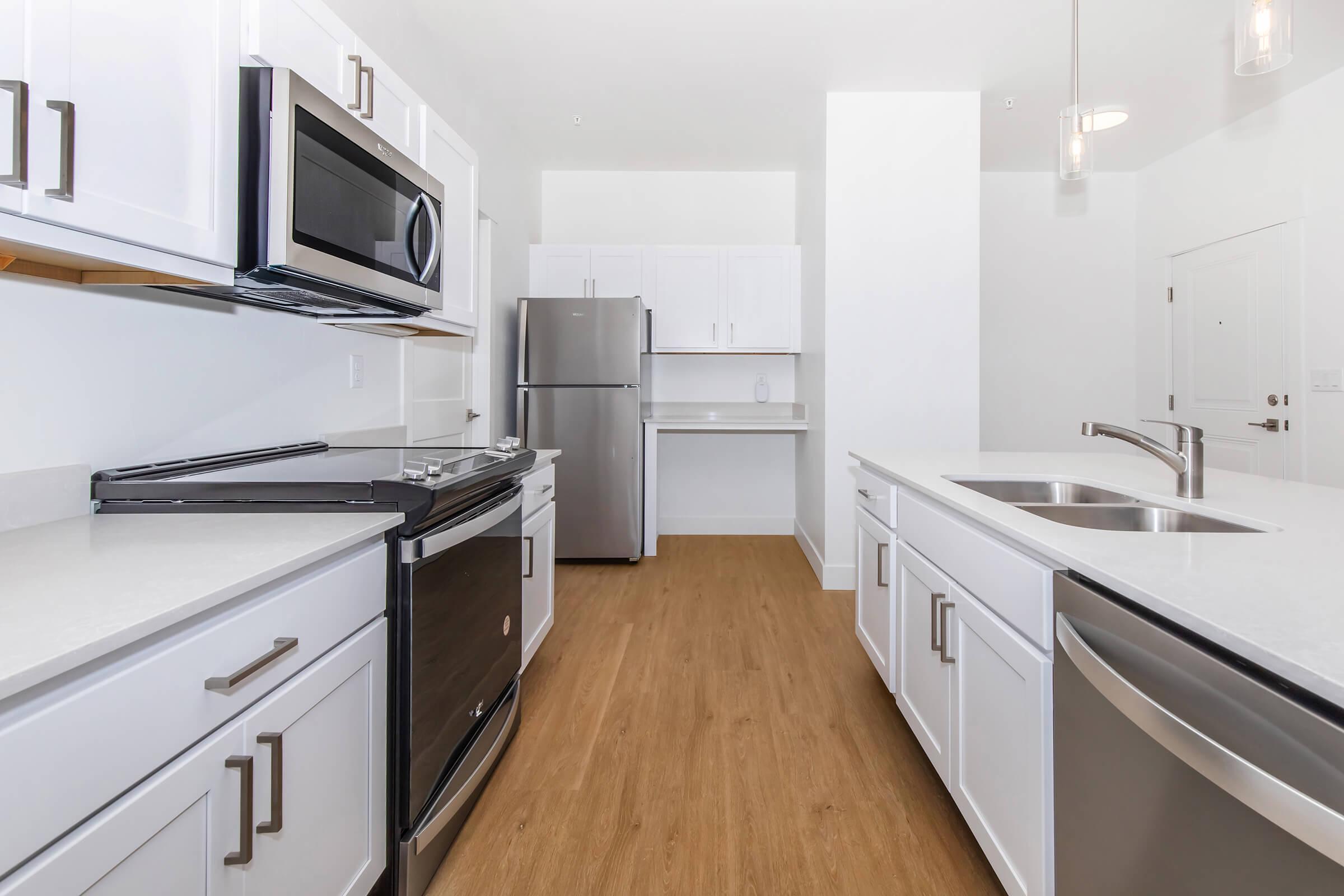 a kitchen with a sink and a refrigerator