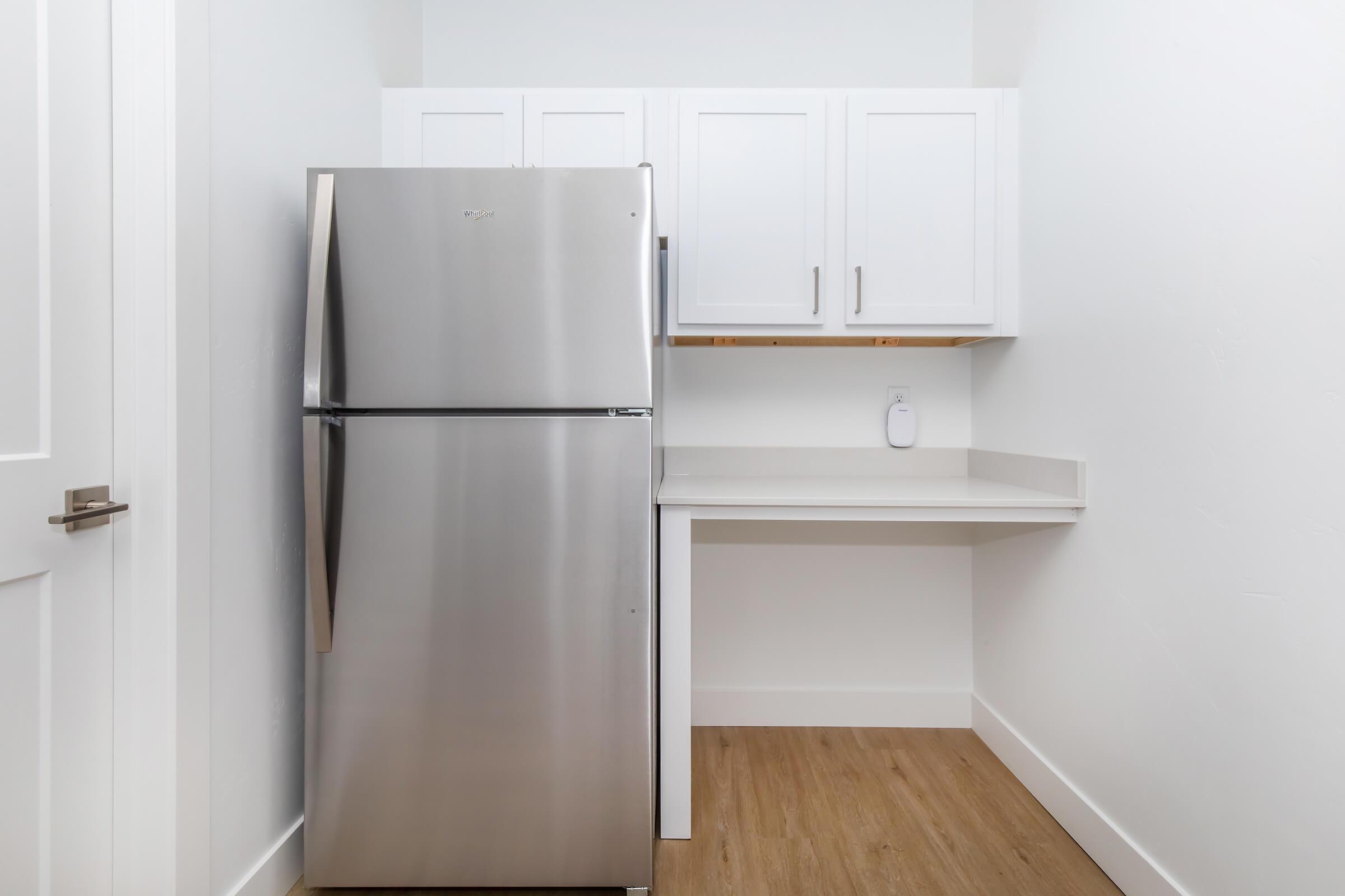 a microwave oven sitting on top of a refrigerator