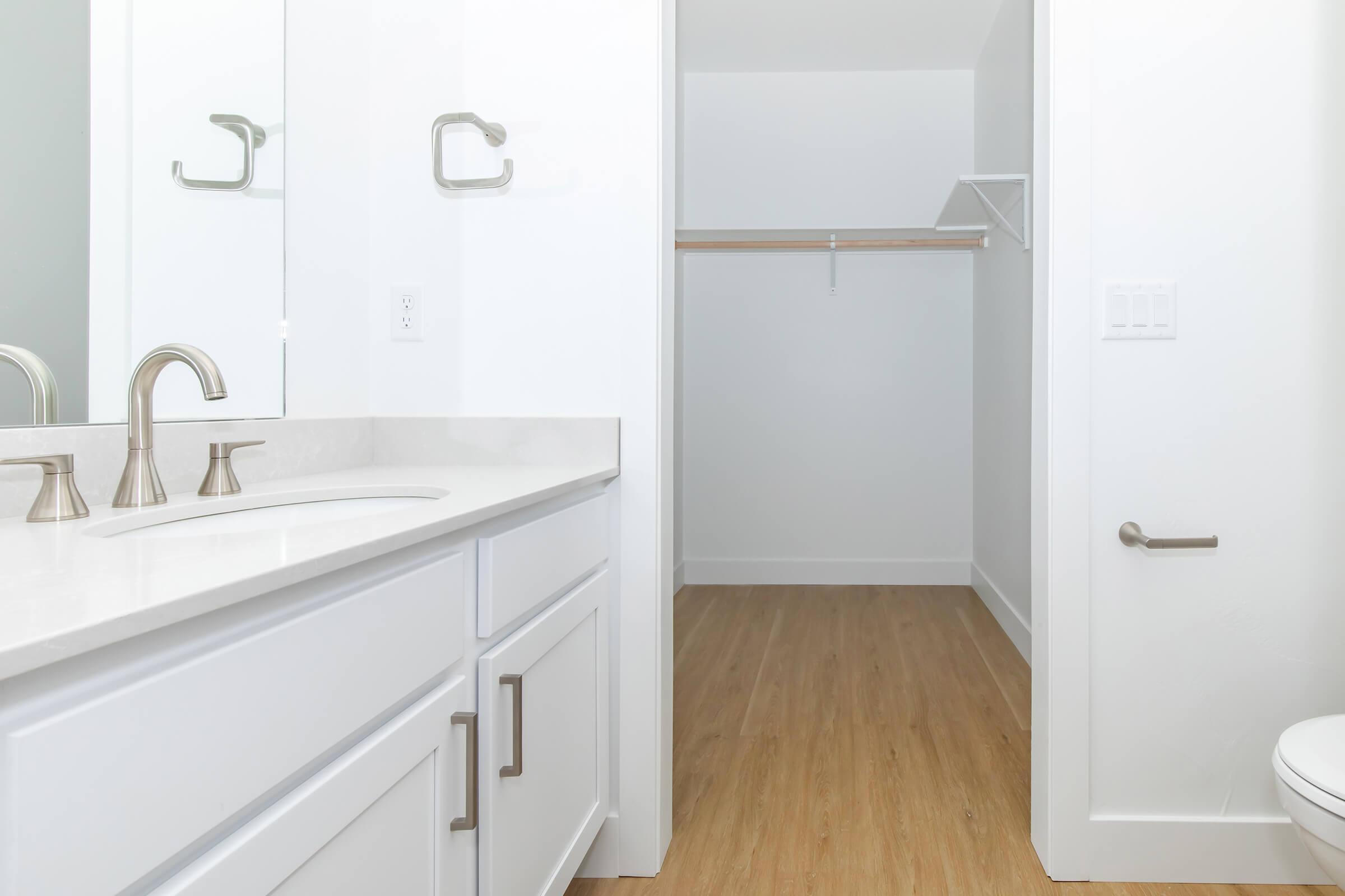 a kitchen with a sink and a mirror