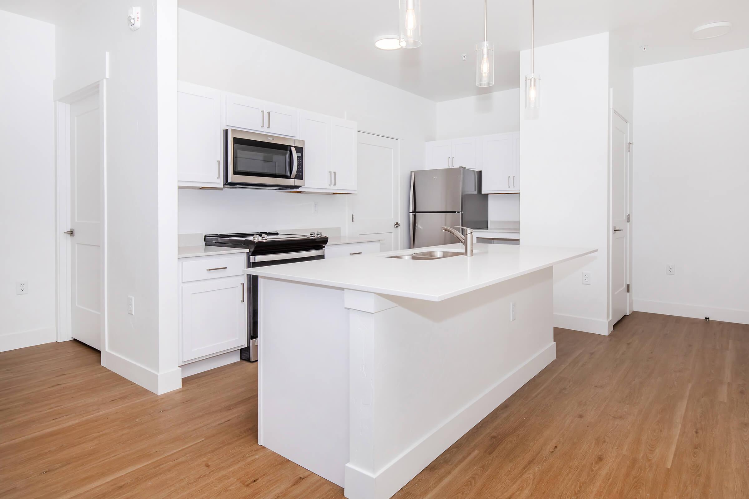 a kitchen with a wood floor