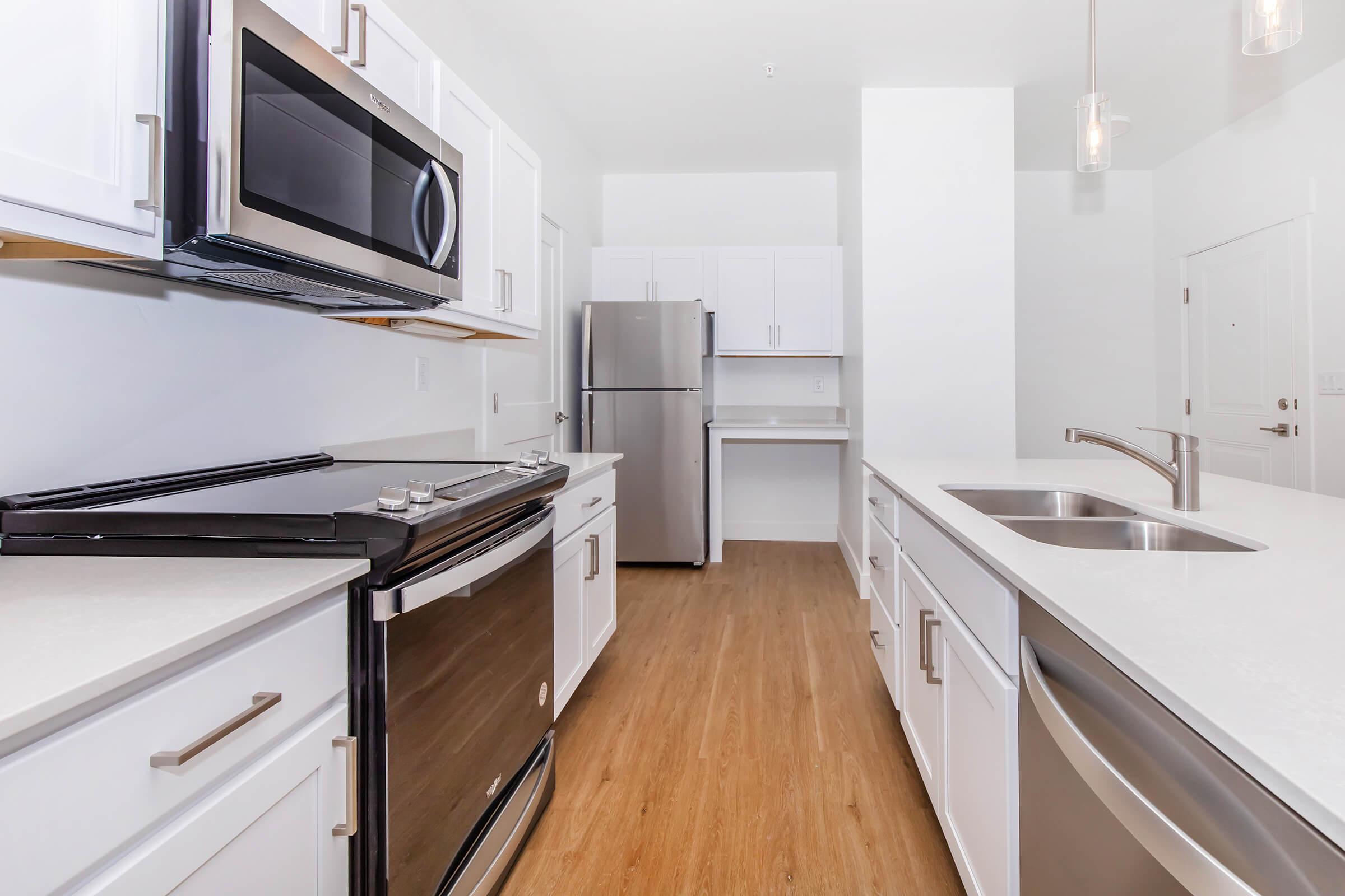 a kitchen with stainless steel appliances and wooden cabinets