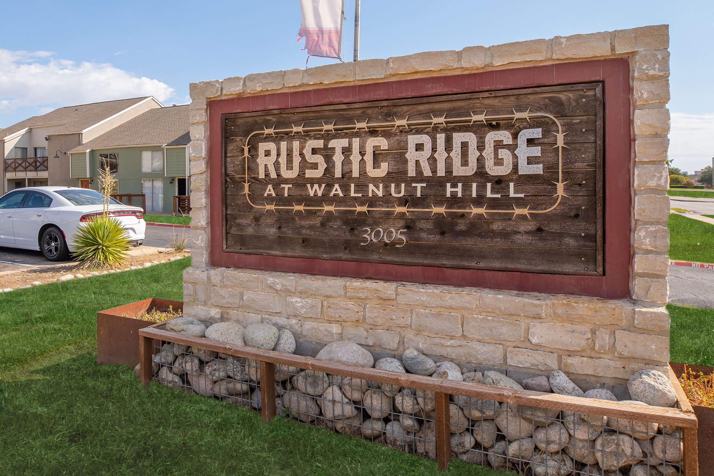 a sign in front of a brick building