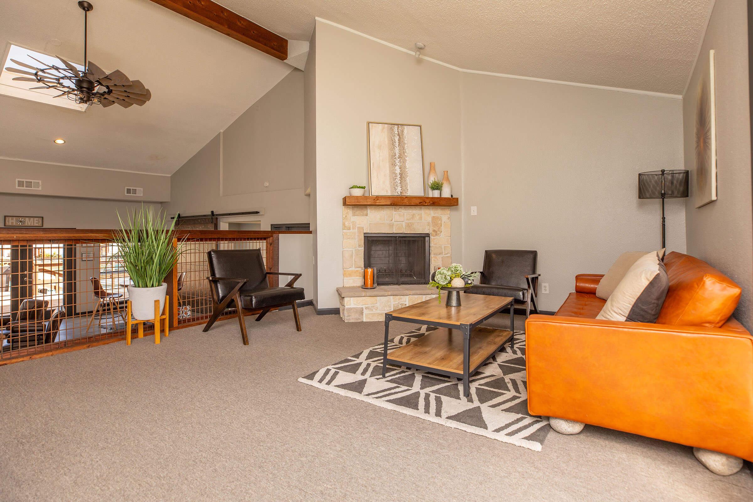 a living room filled with furniture and a fireplace