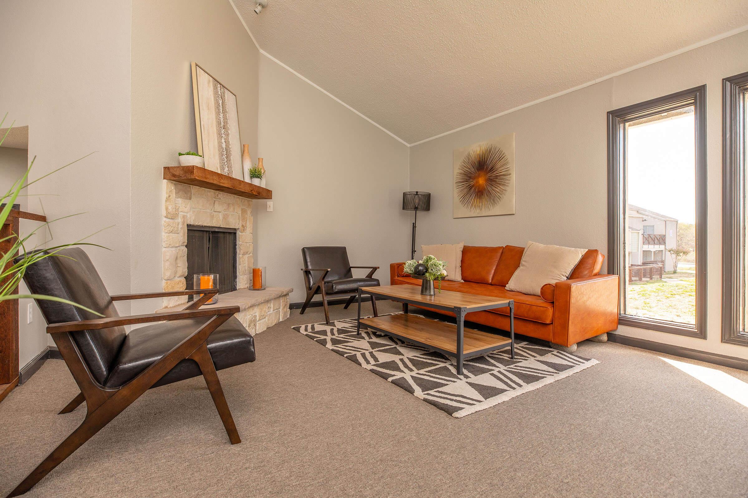 a living room filled with furniture and a fireplace