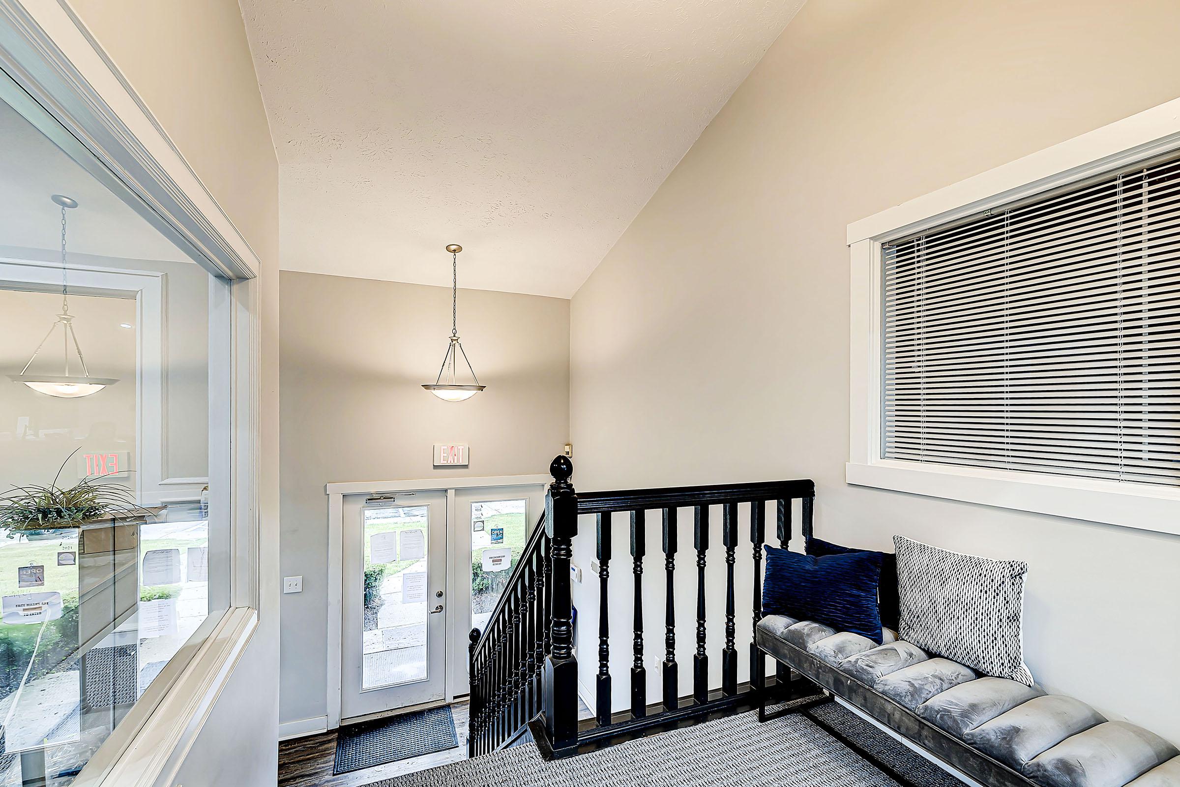 a room filled with furniture and a large window