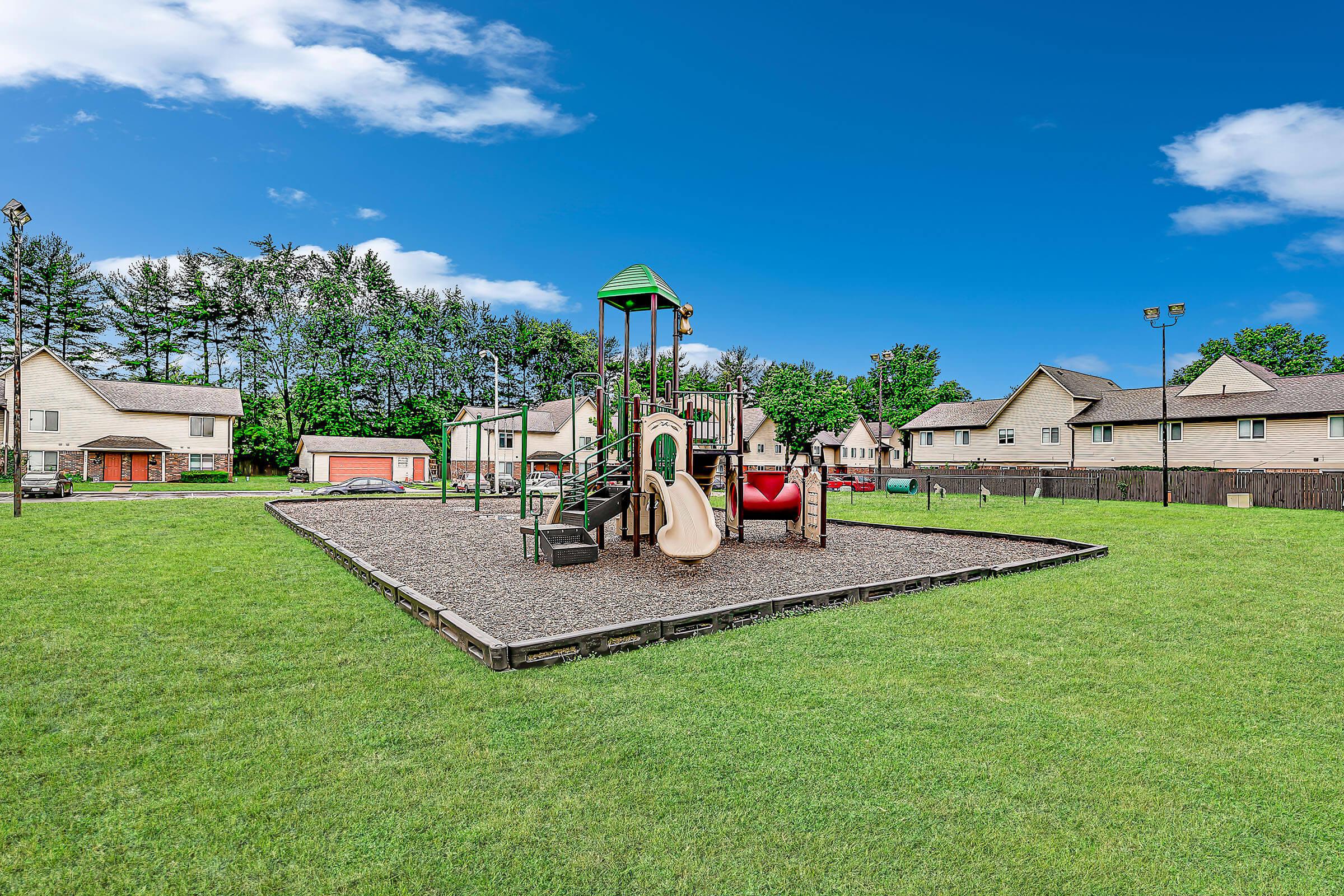 a group of lawn chairs sitting on top of a lush green field