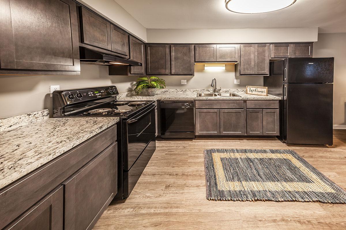 a modern kitchen with stainless steel appliances and wooden cabinets