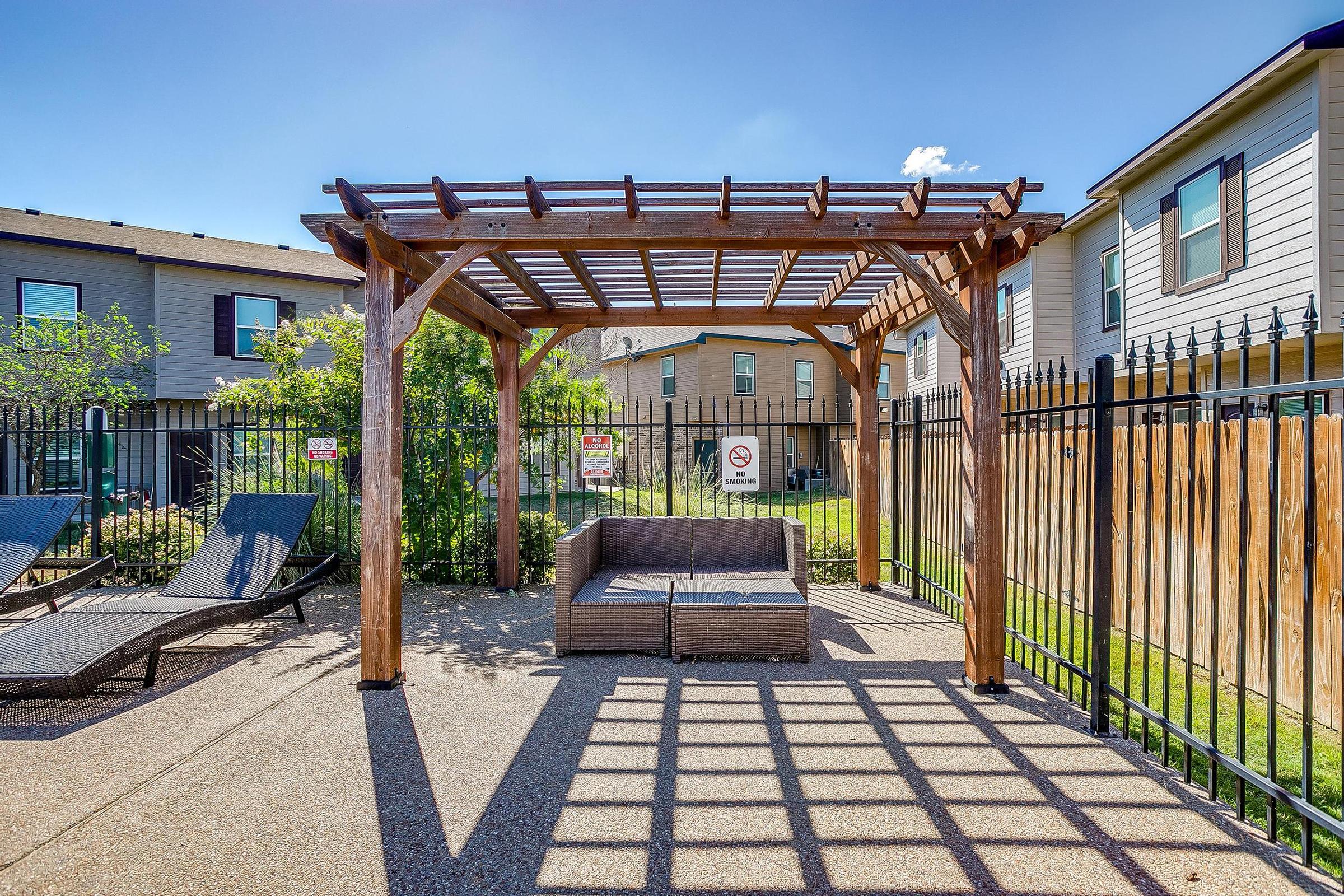 a house with a fence in front of a building