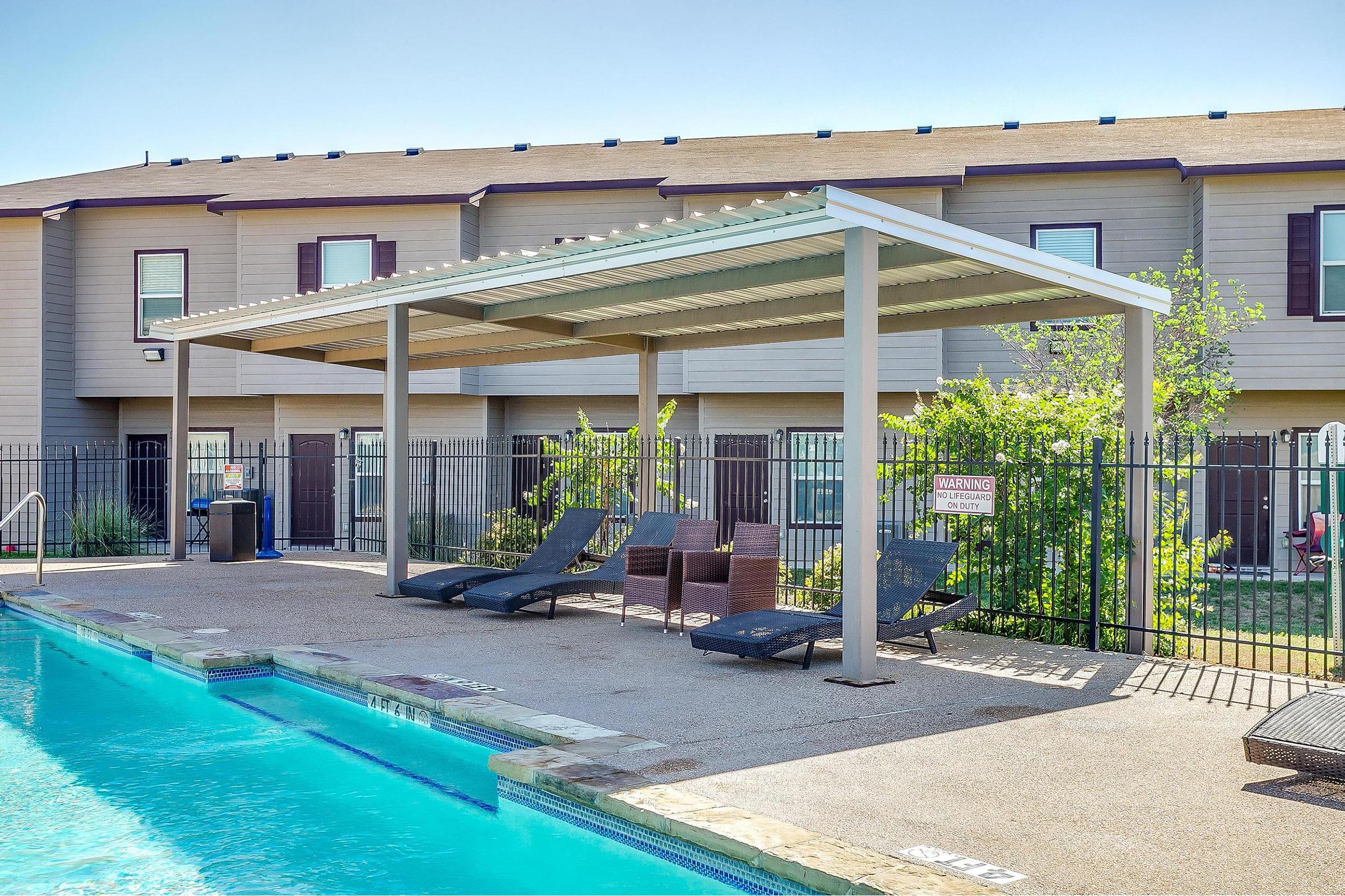 a house with a pool outside of a building