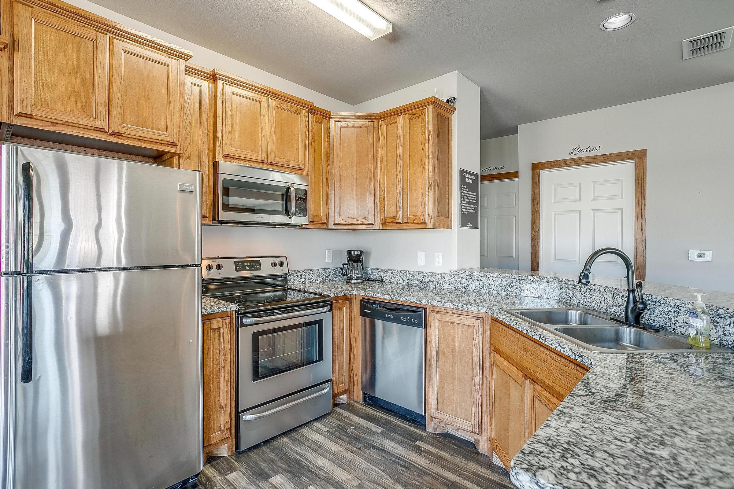 a kitchen with stainless steel appliances and wooden cabinets