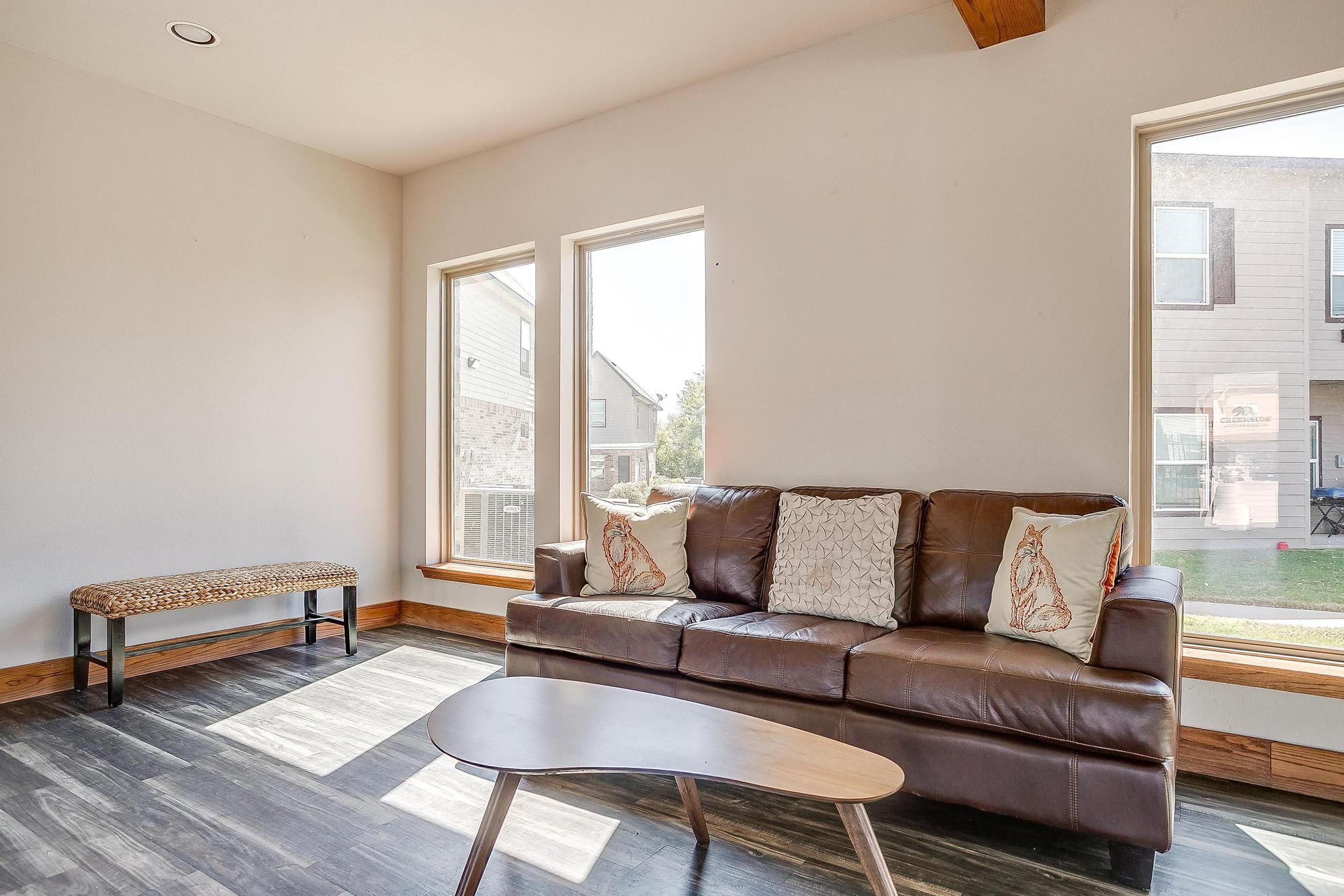 a living room filled with furniture and a large window