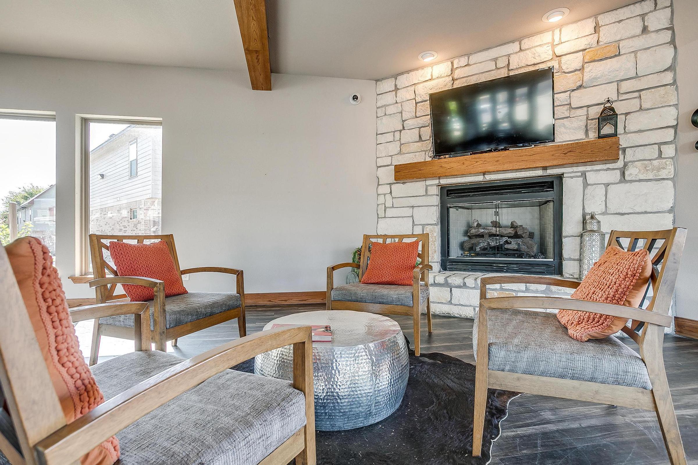 a living room filled with furniture and a fire place sitting in a chair