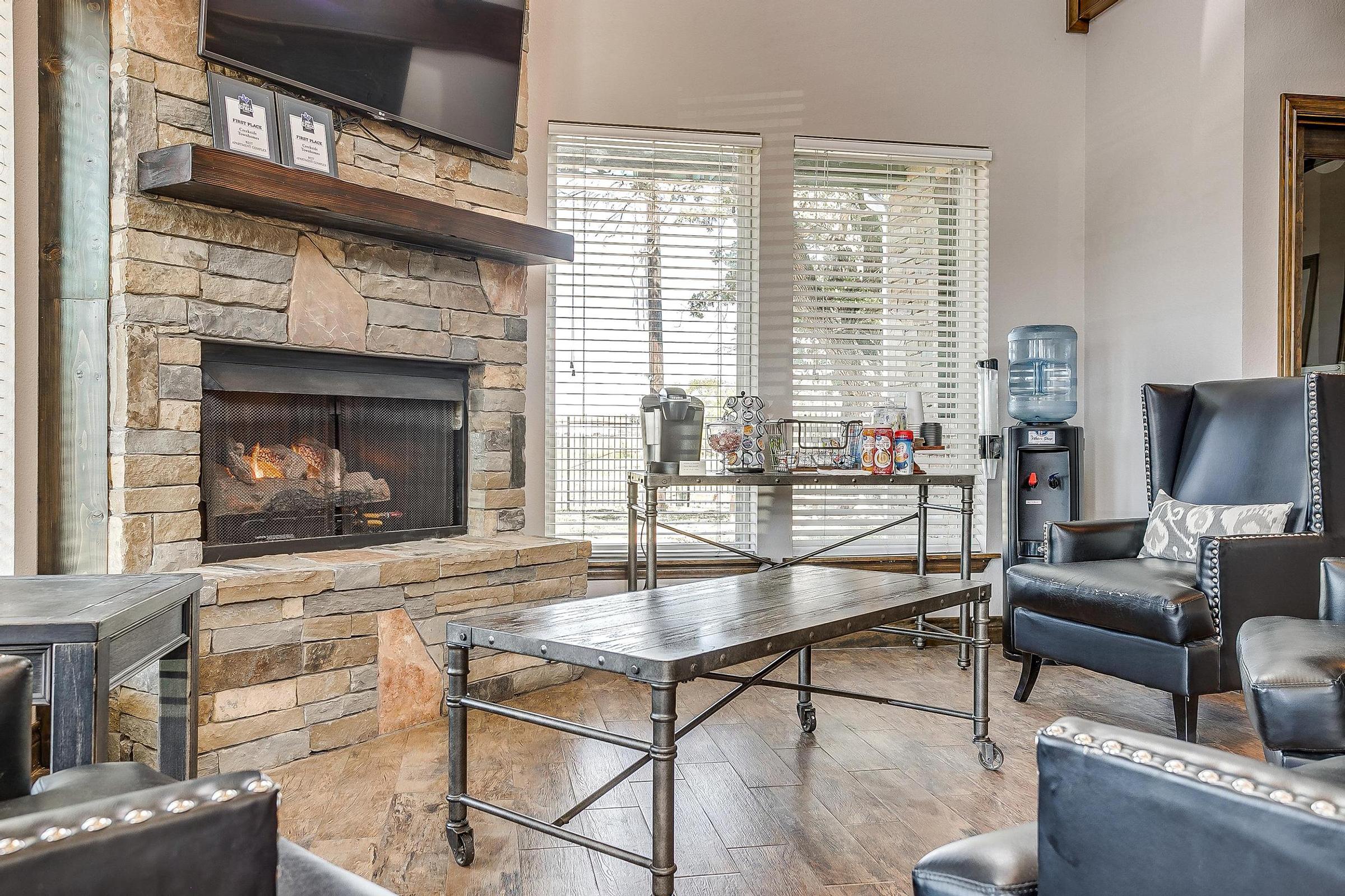 a living room filled with furniture and a fireplace