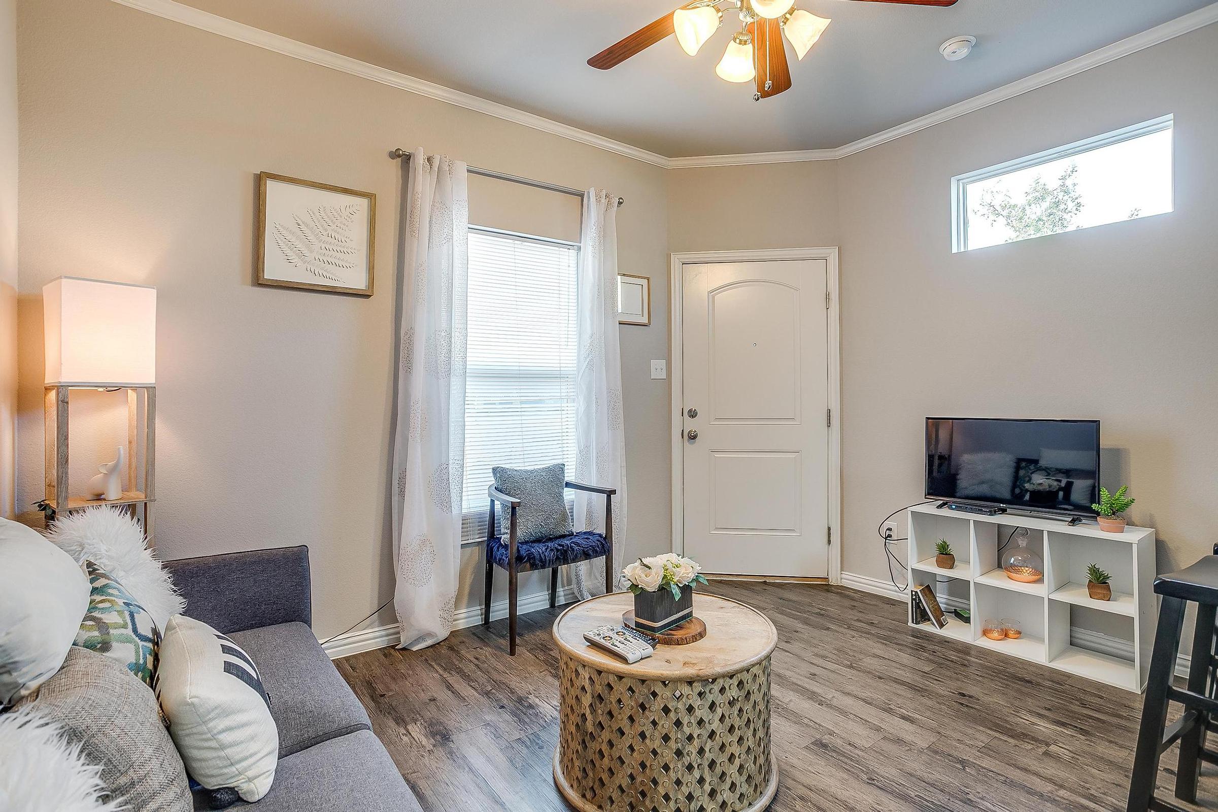 a living room filled with furniture and a mirror