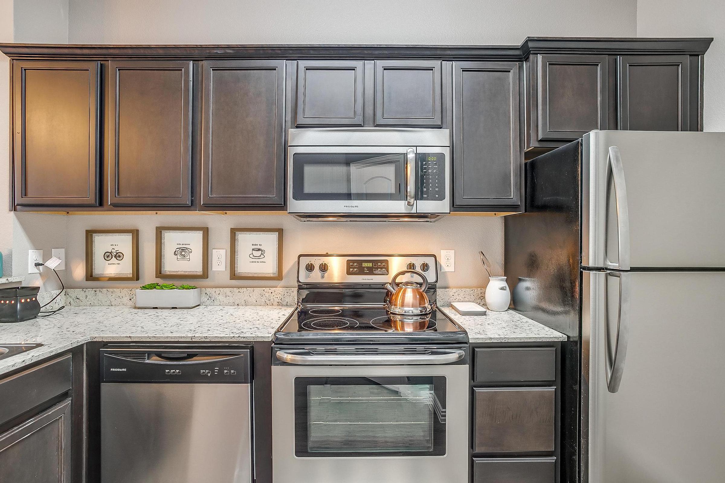 a stove top oven sitting inside of a kitchen