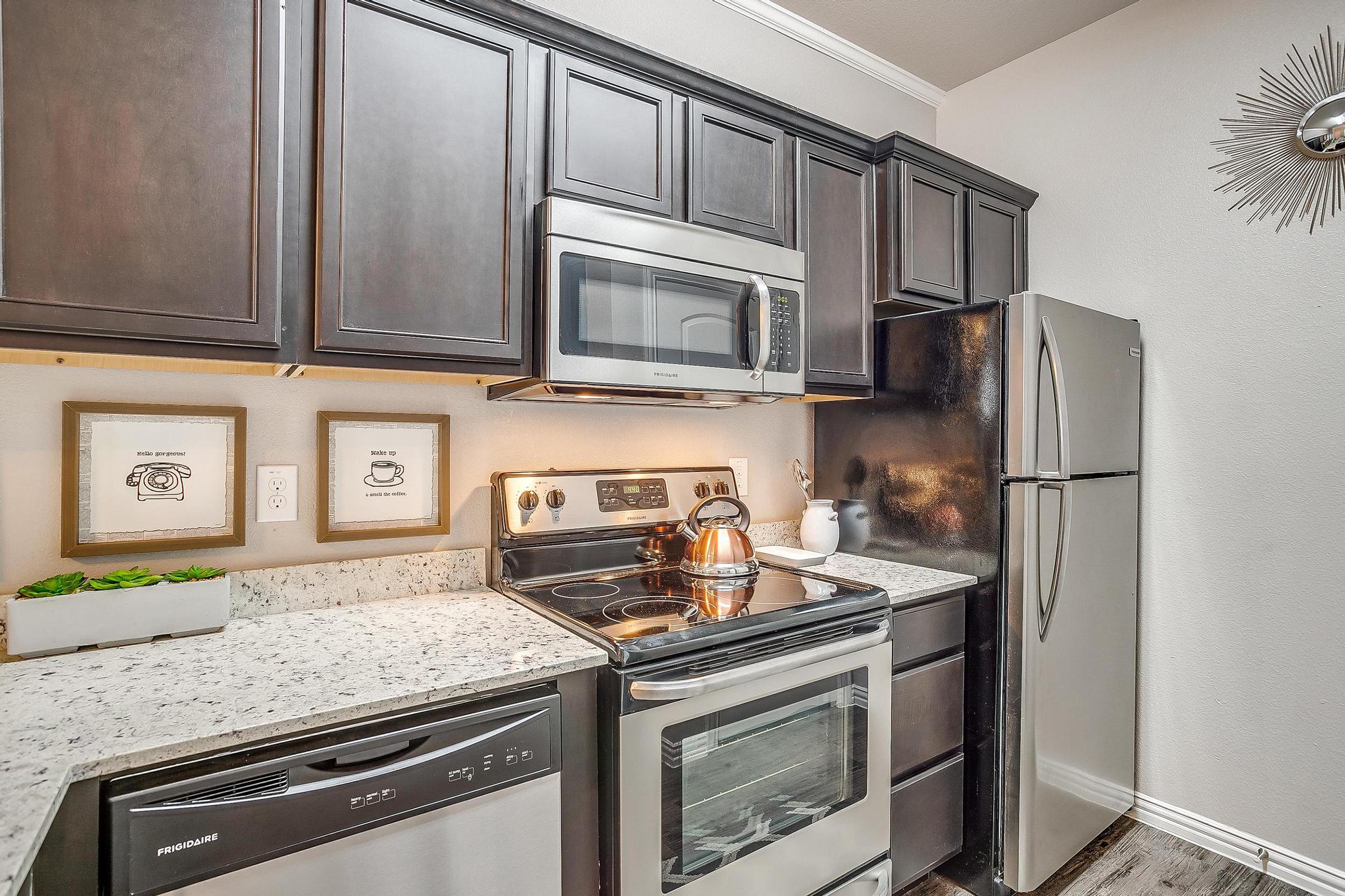 a stove top oven sitting inside of a kitchen