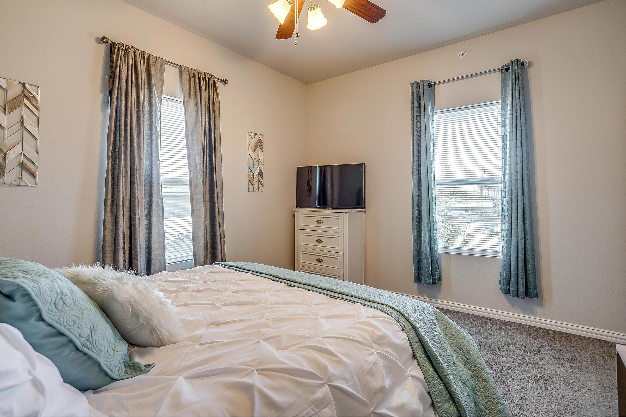 a bedroom with a large bed in a room