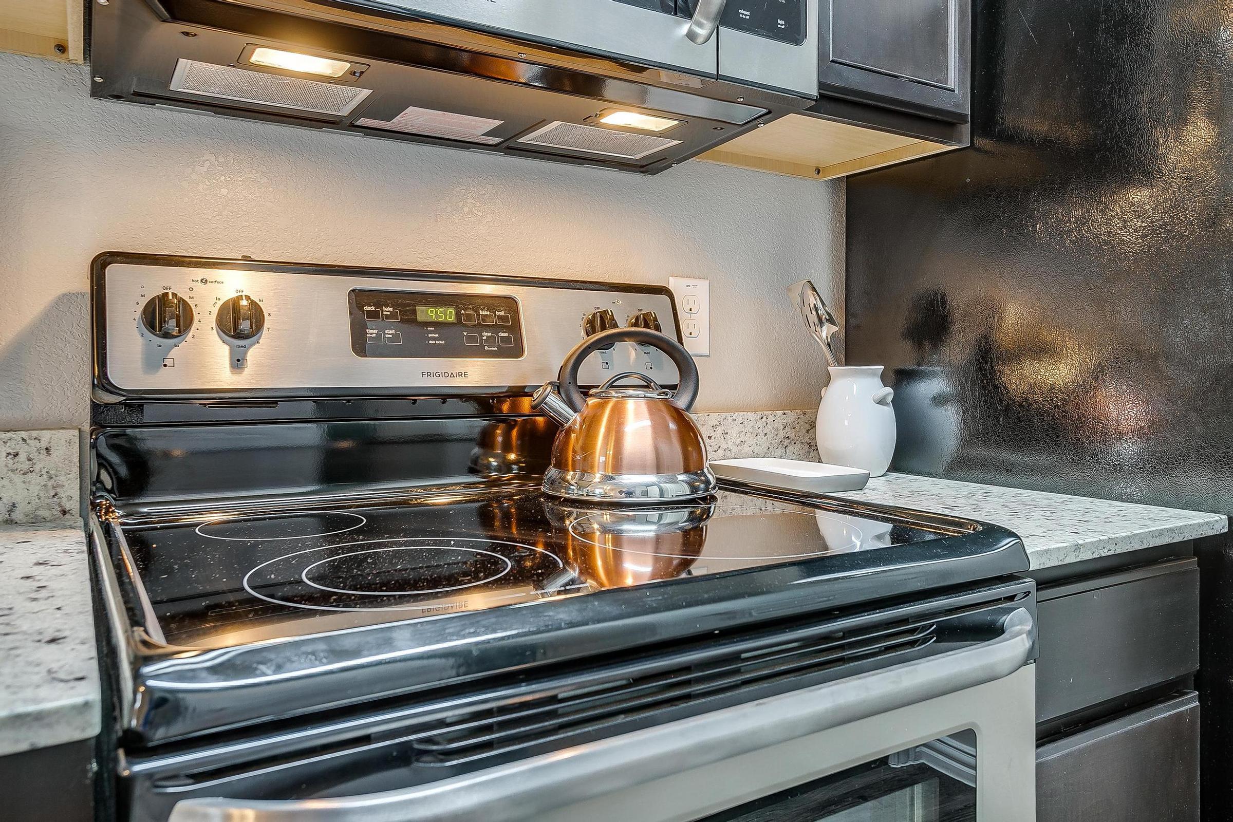 a stove top oven sitting inside of a kitchen