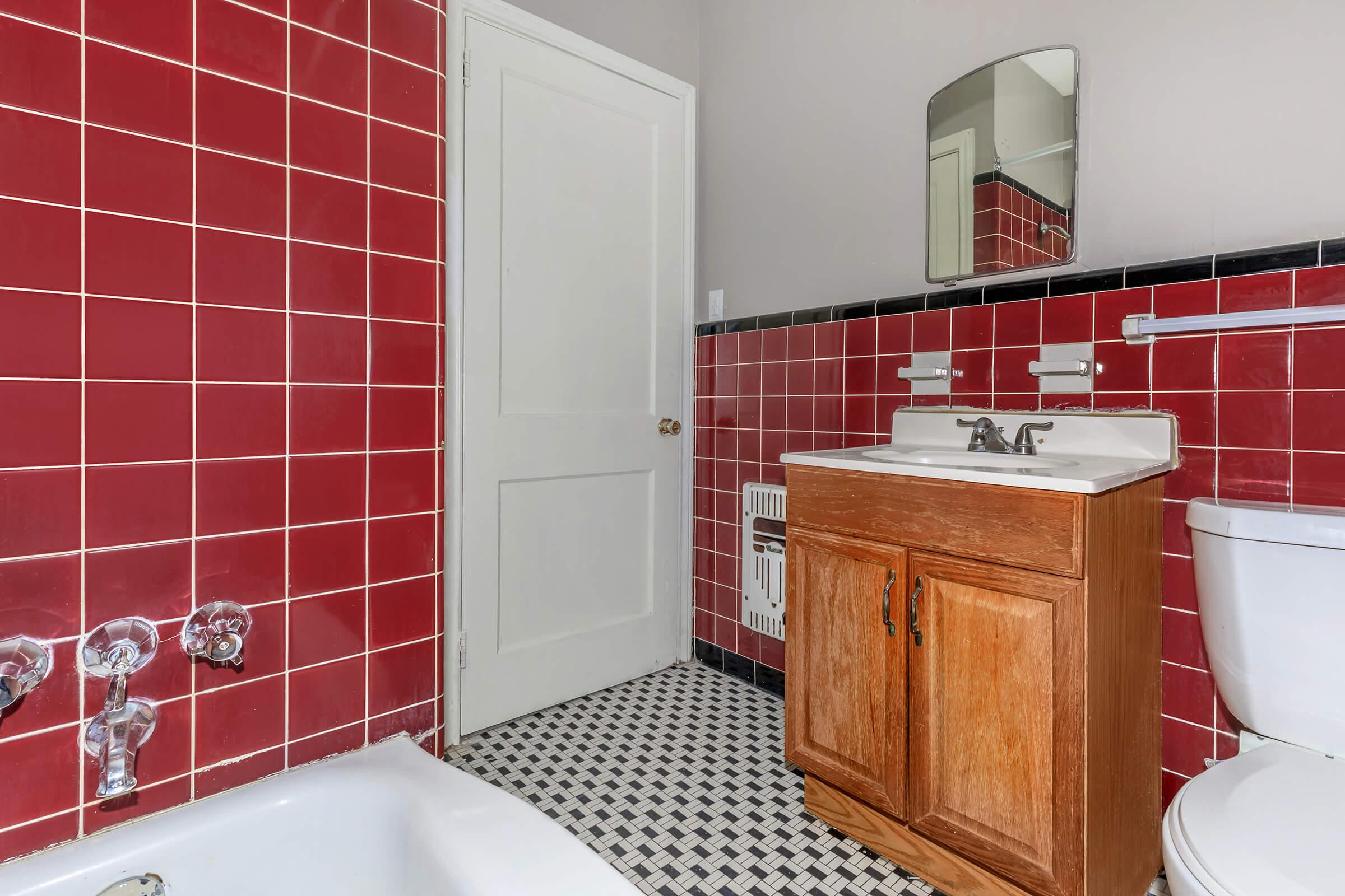 a red cabinet next to a sink