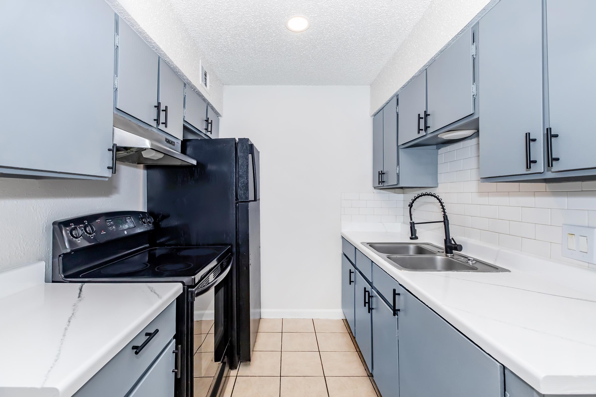 a kitchen with a stove sink and refrigerator