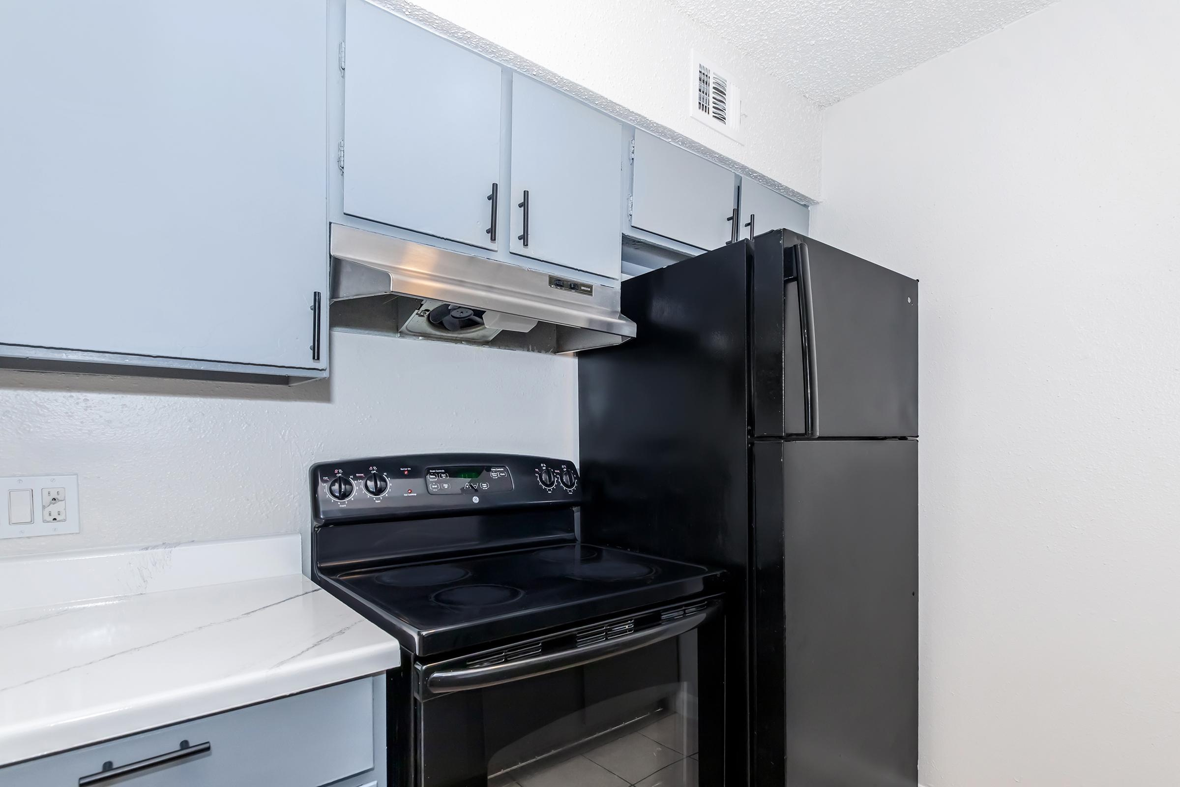 a stove top oven sitting inside of a kitchen