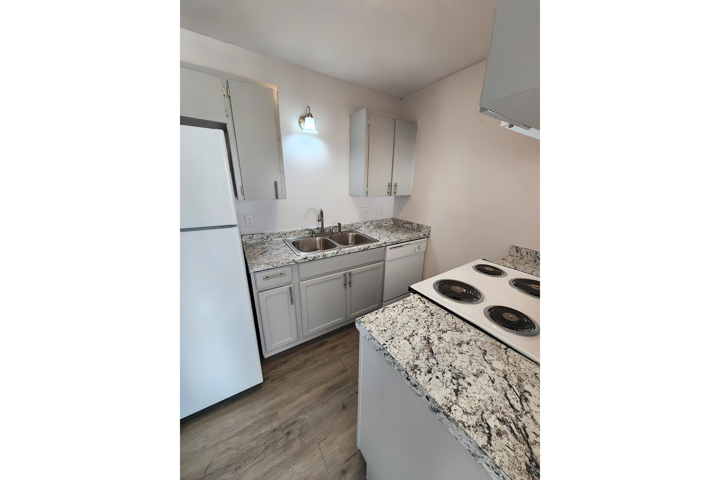 a kitchen with a sink and a mirror