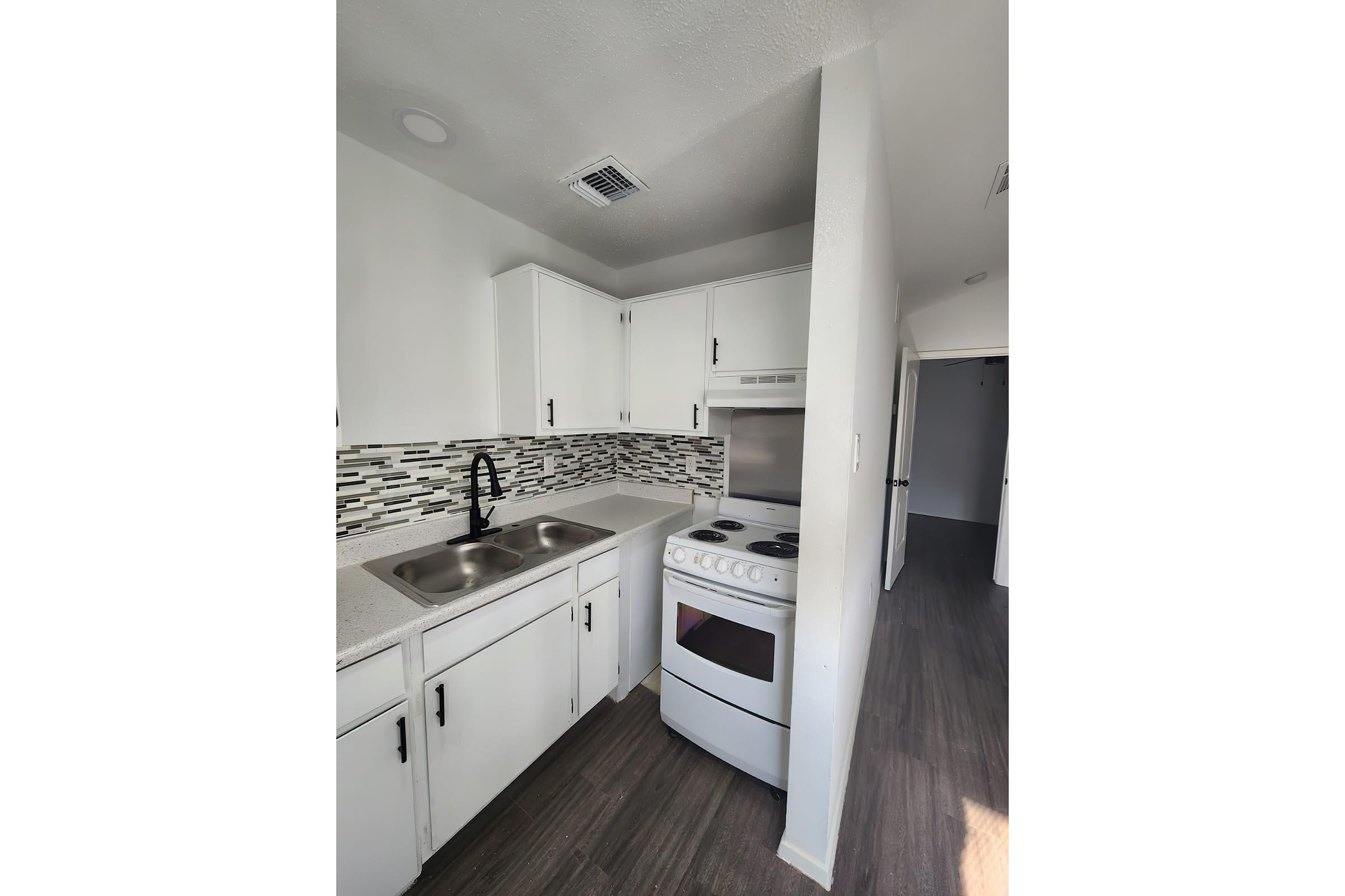 a kitchen with a stove and a sink