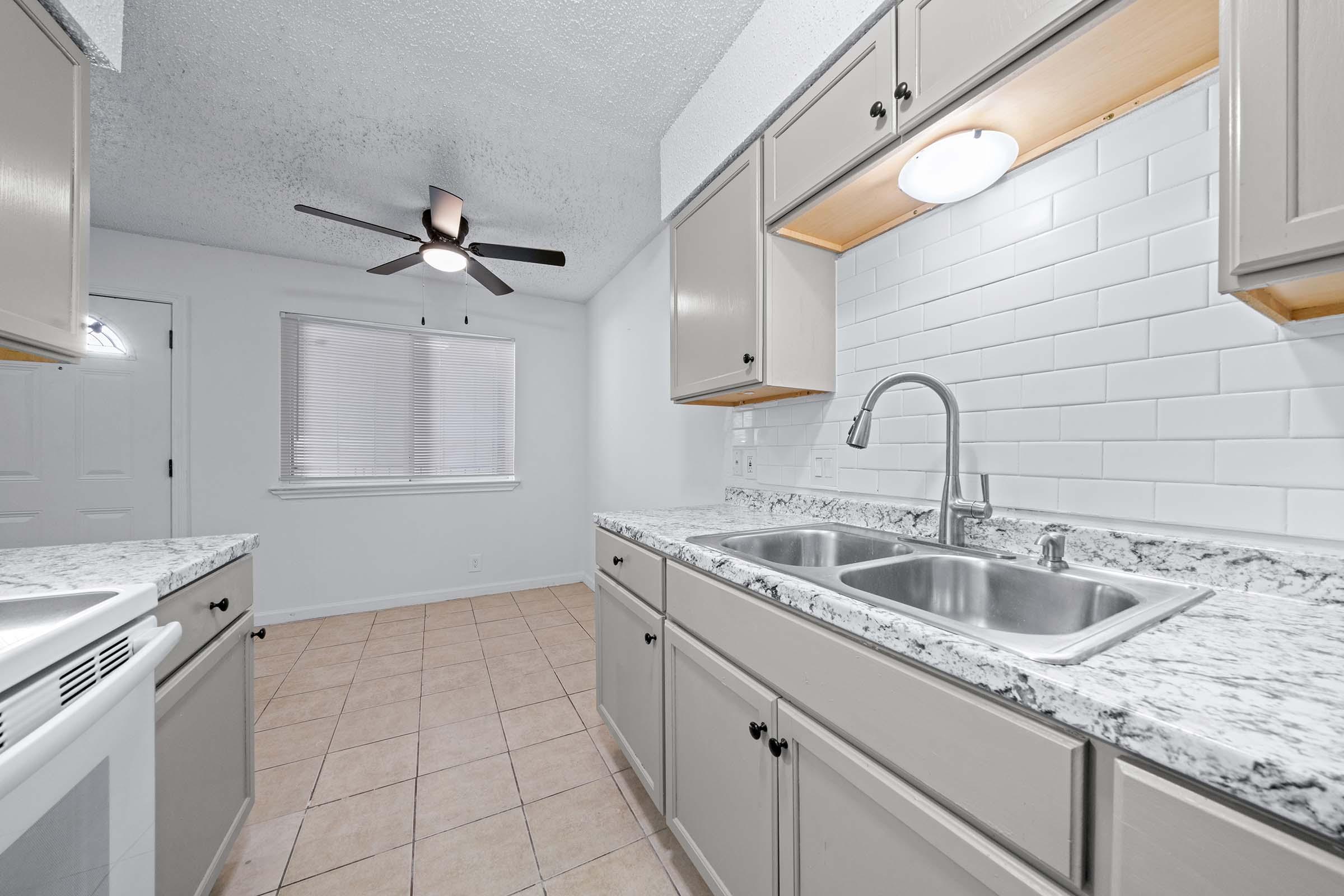 a kitchen with a sink and a window