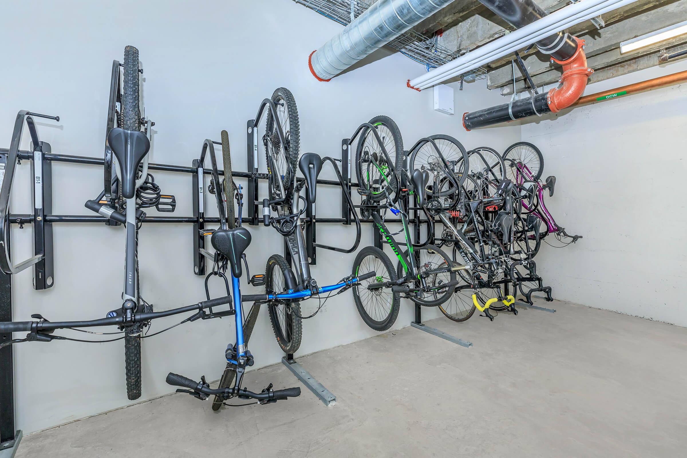 a bicycle leaning against a metal rack