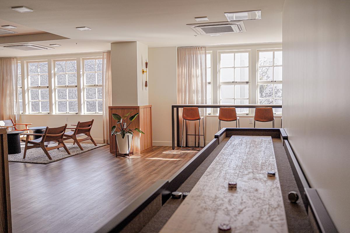 a living room filled with furniture and a large window