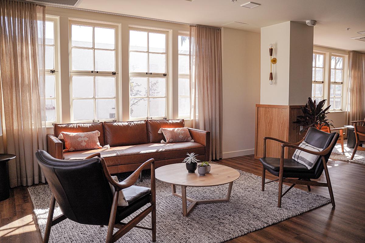 a living room filled with furniture and a large window