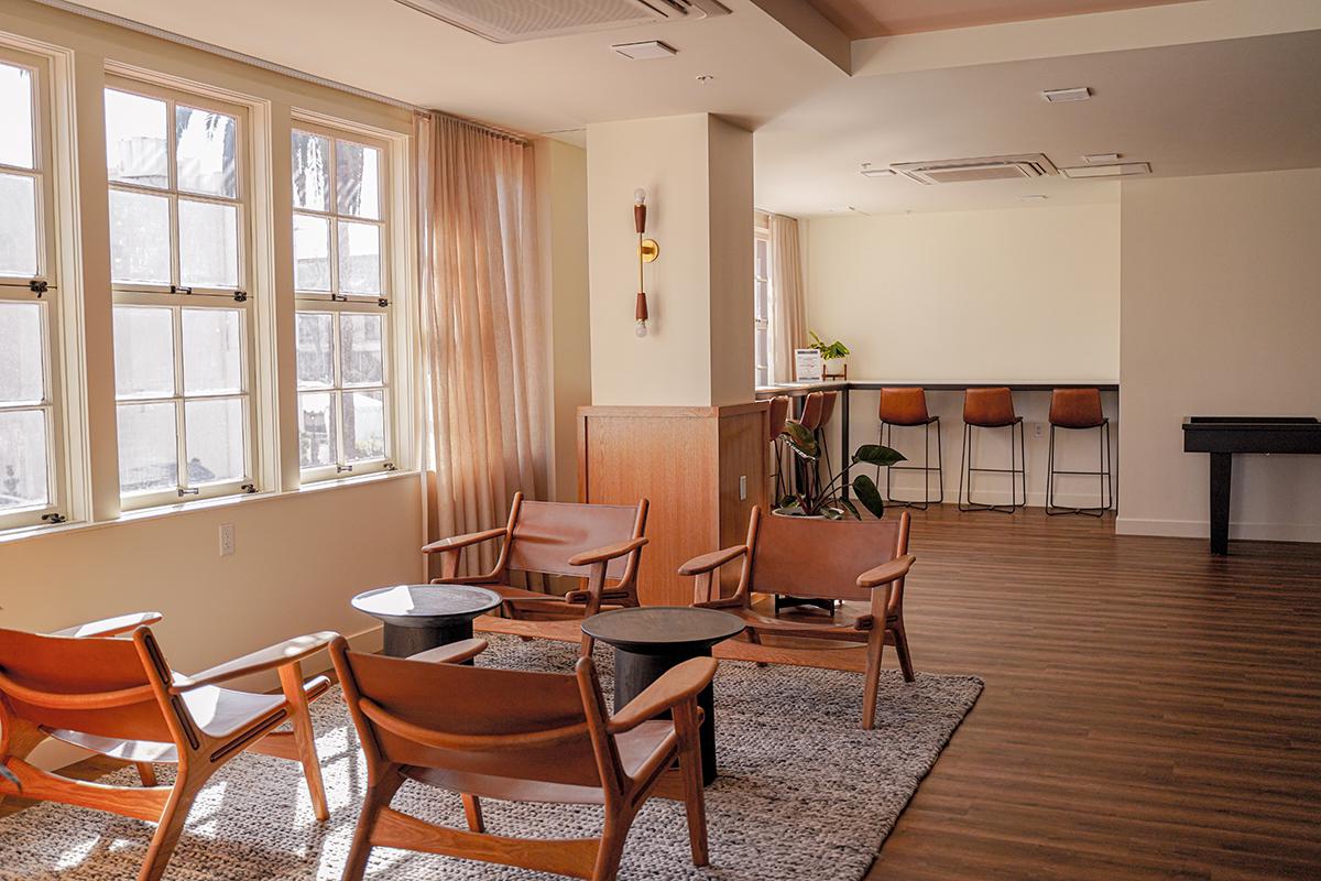 a living room filled with furniture and a large window