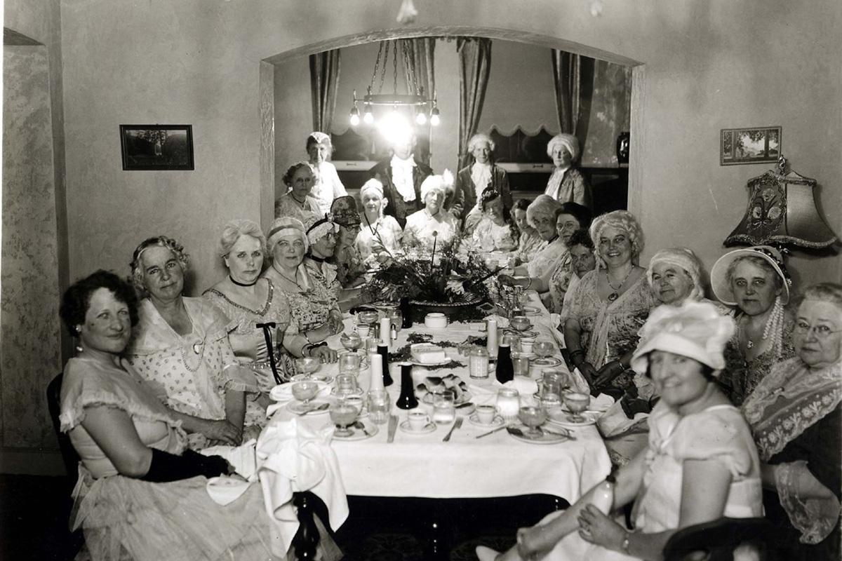 a group of people sitting at a table posing for a photo