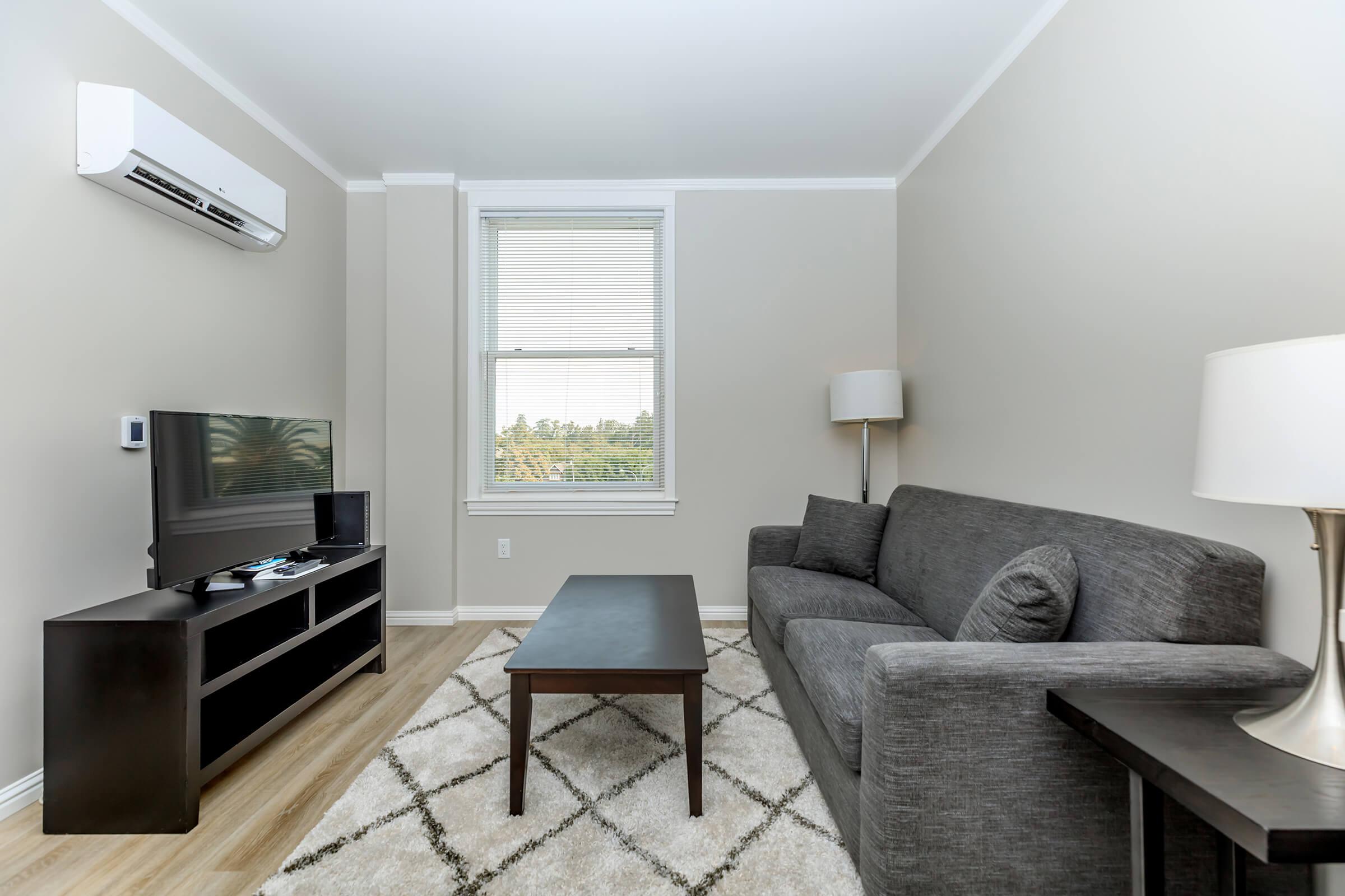 a living room filled with furniture and a flat screen tv