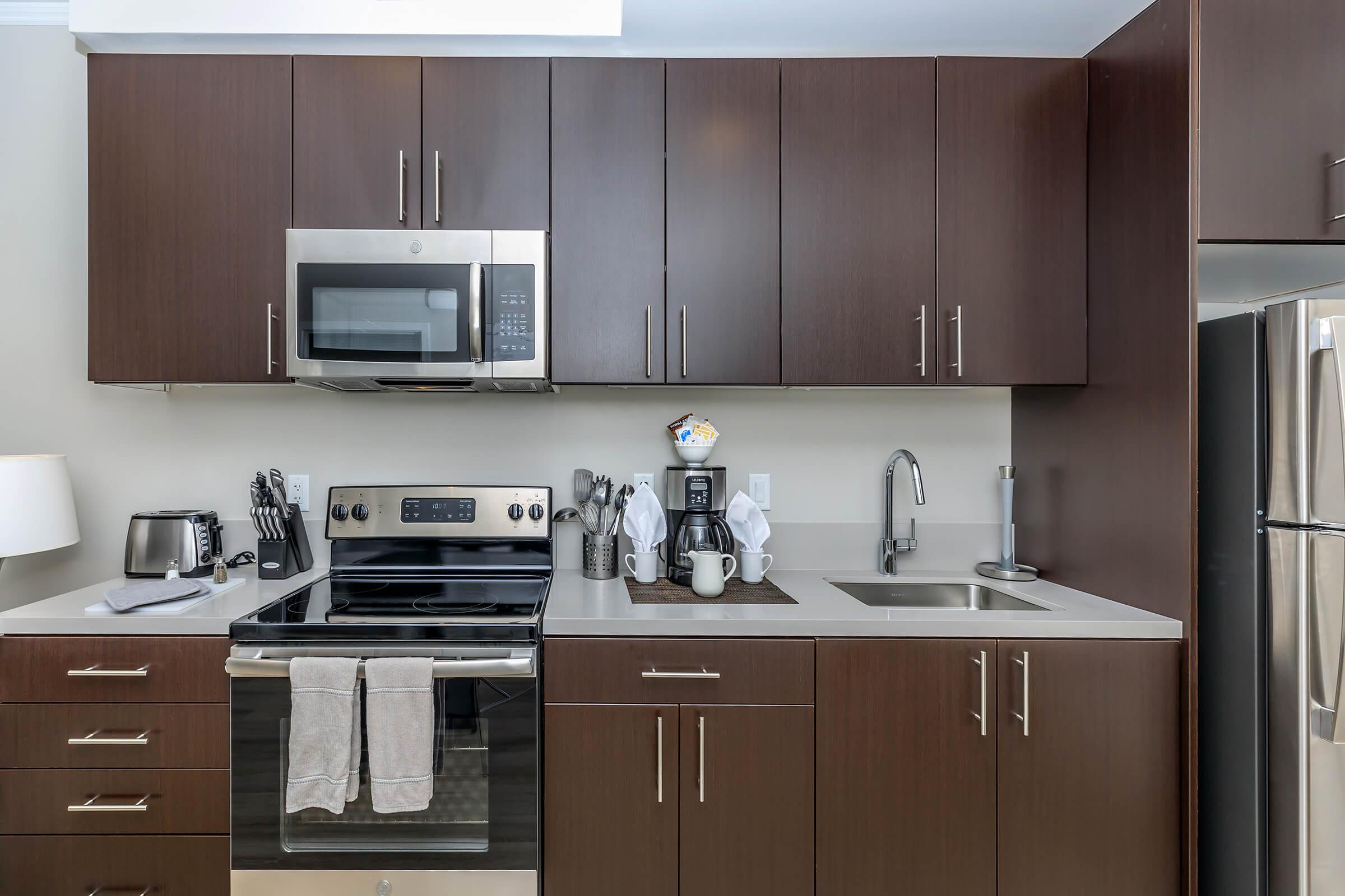 a kitchen with stainless steel appliances and wooden cabinets