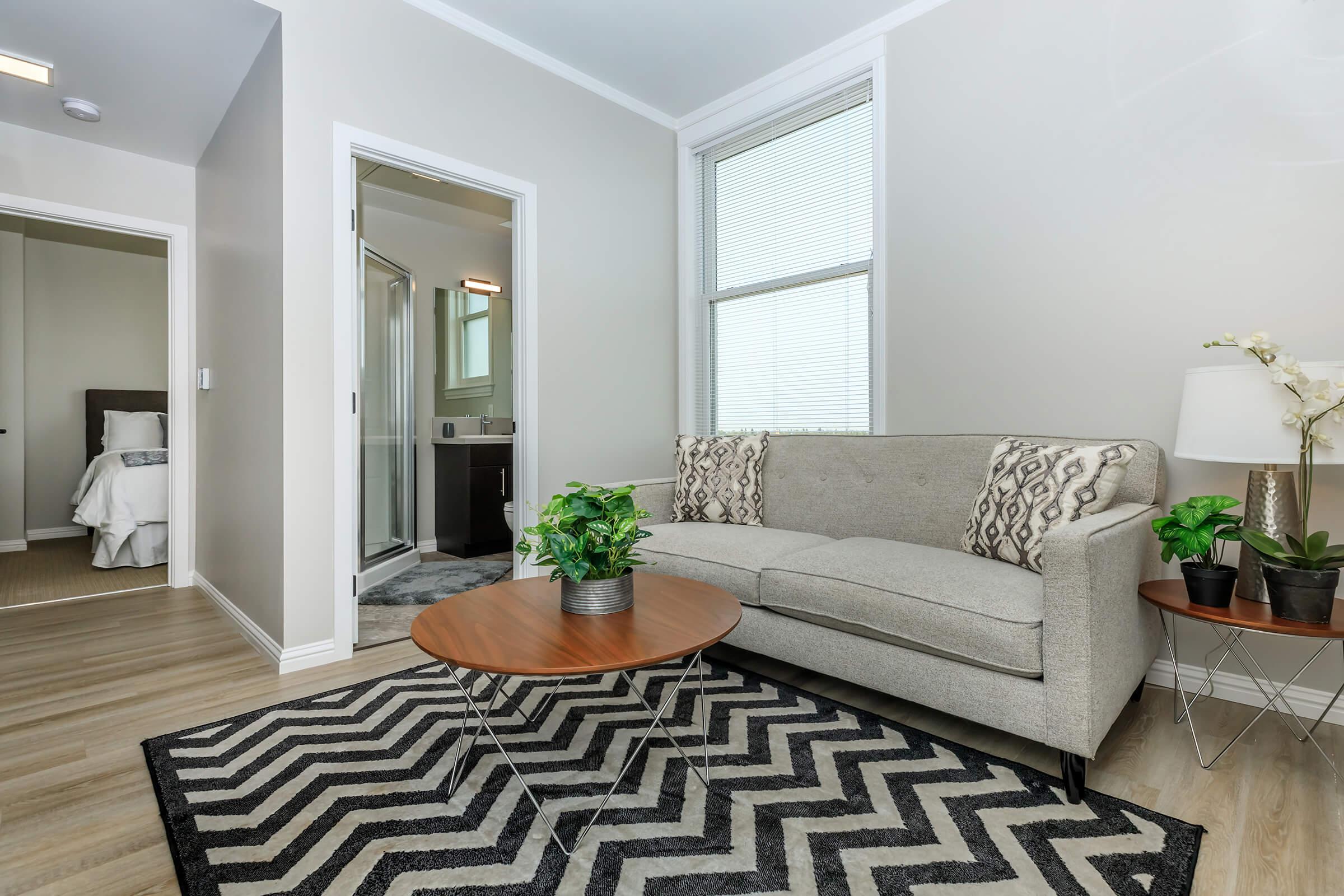 a living room filled with furniture and a large window