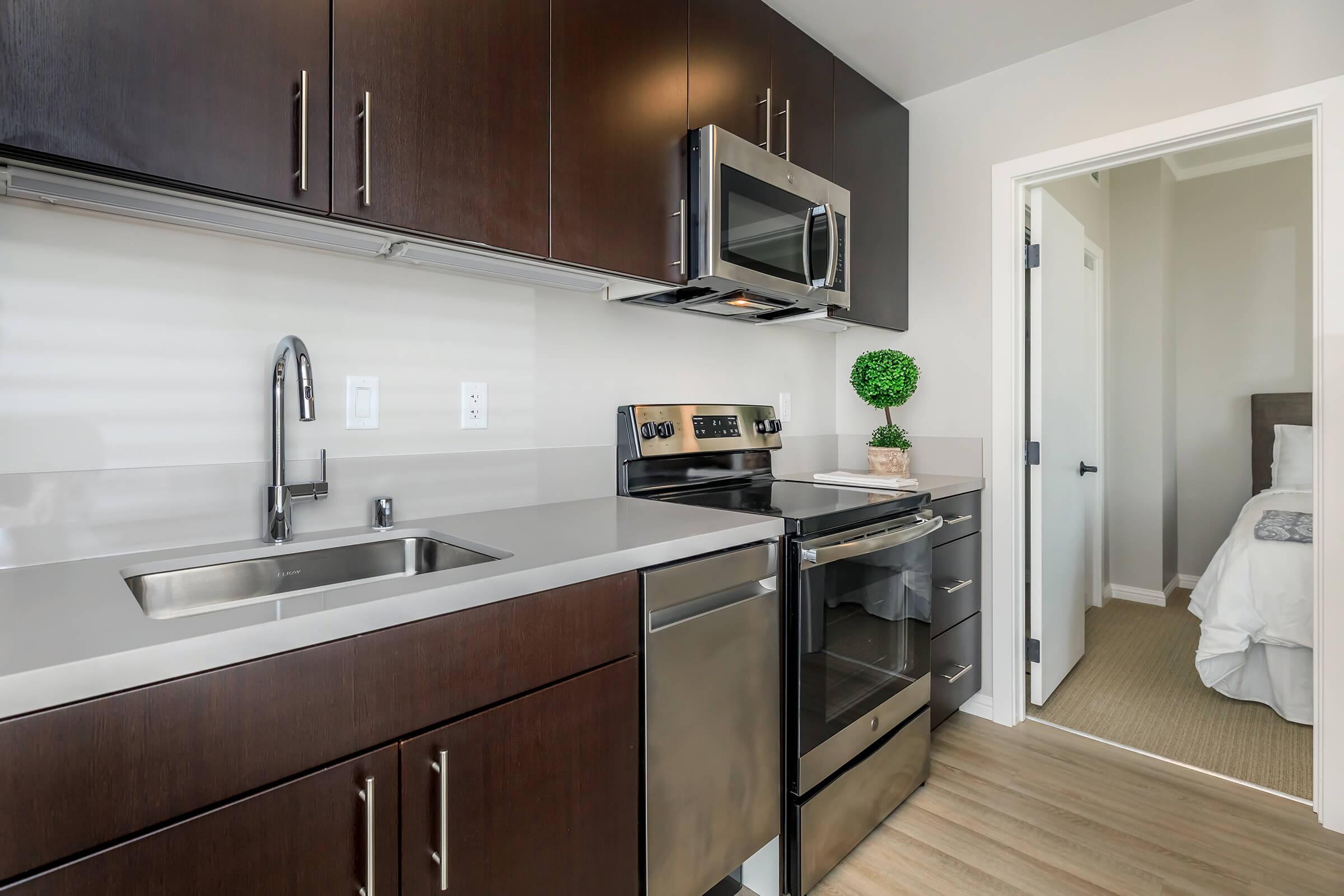 a kitchen with a sink and a mirror